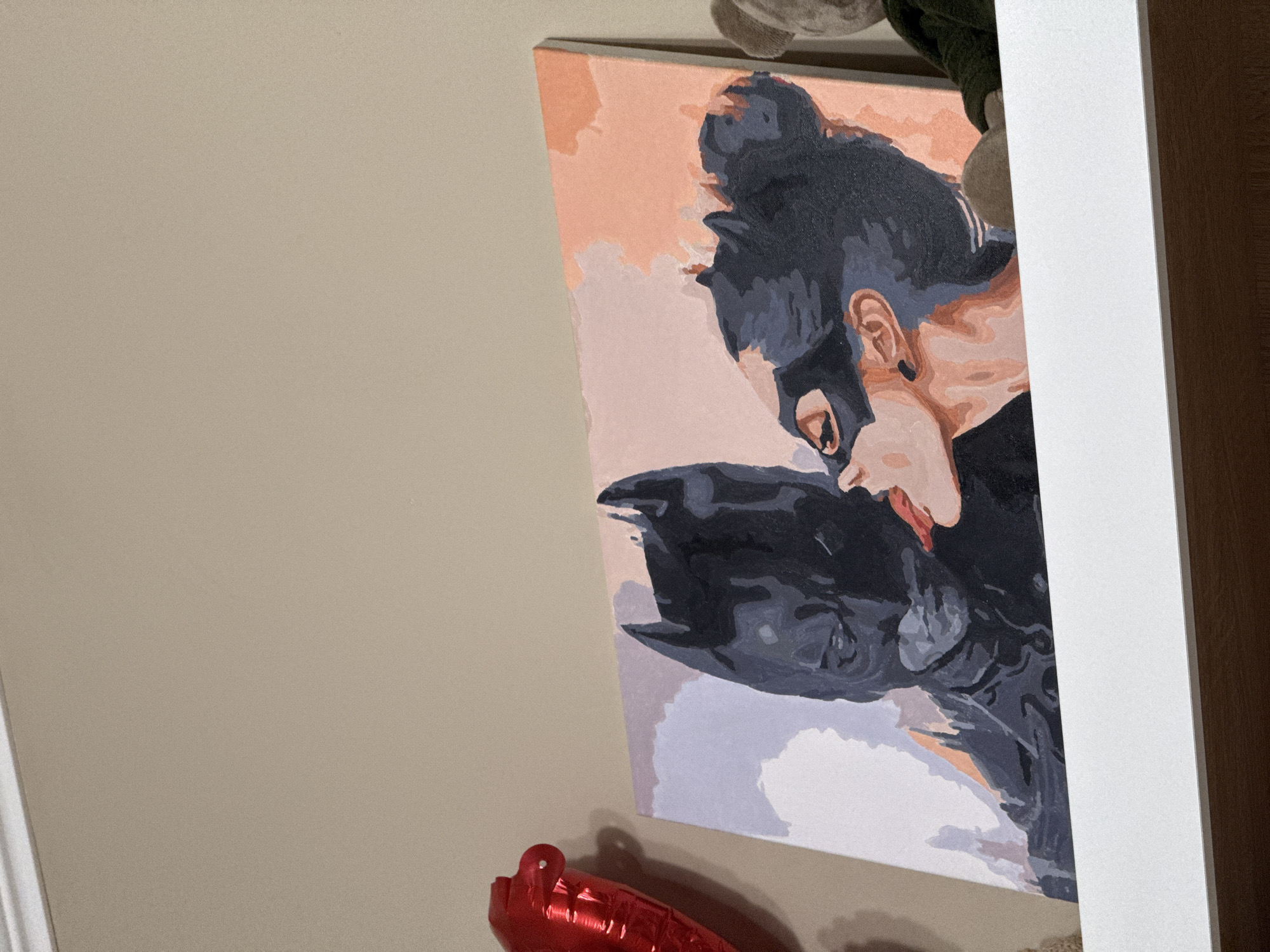 Indoor space displays Batman artwork and personal shelf items