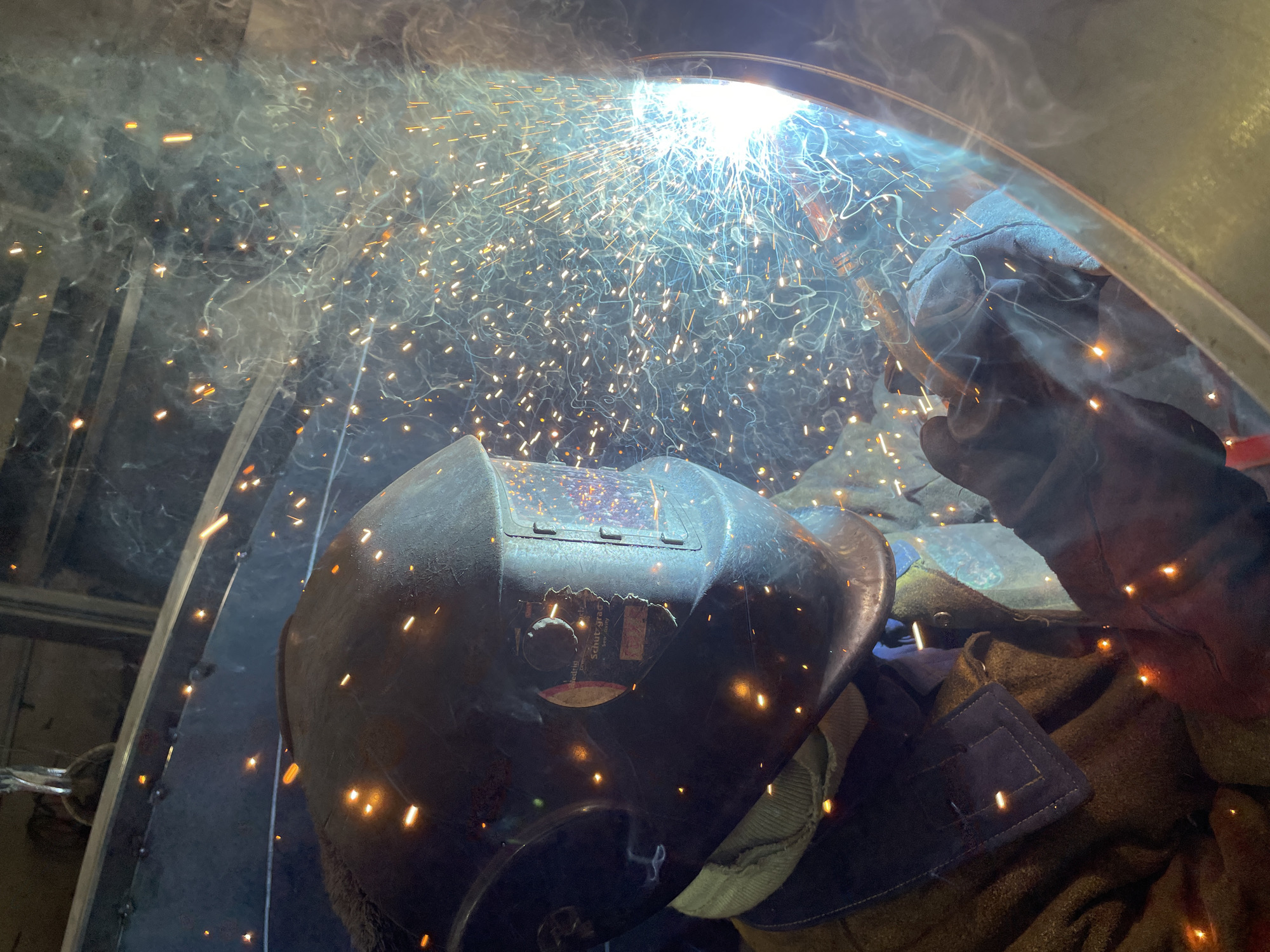 Welder works inside metal structure in Montenegro