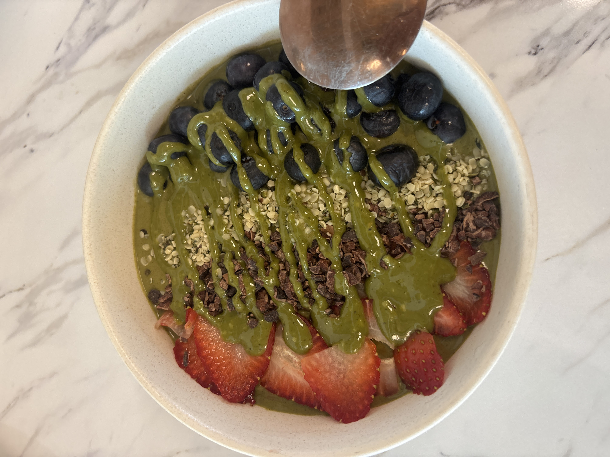 Smoothie bowl photographed on marble surface in Mexico City
