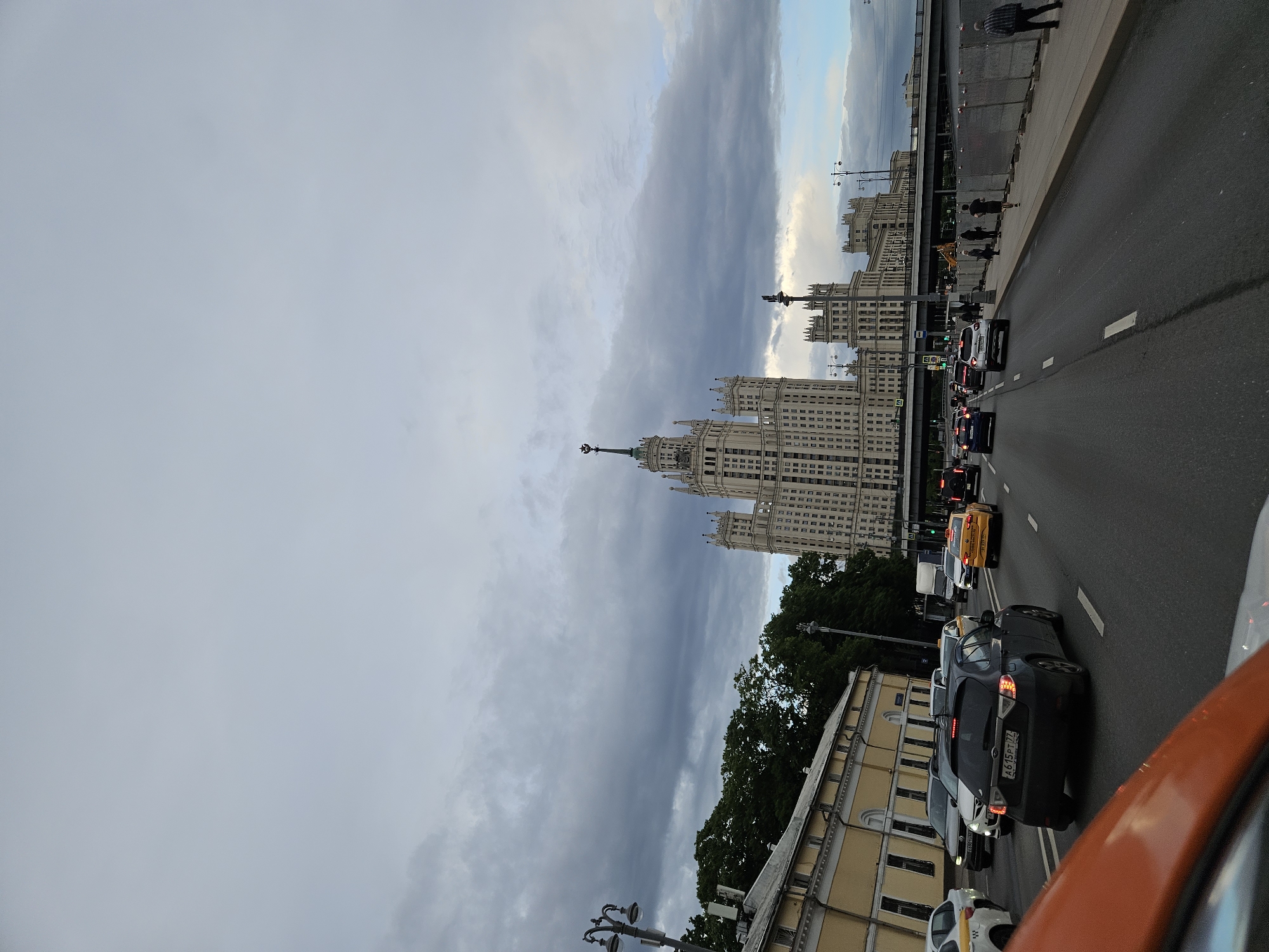 Moscow witnesses document Seven Sisters skyscraper on cloudy afternoon