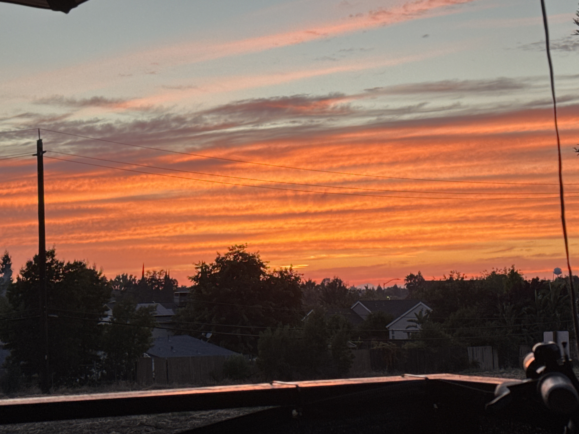 Fiery summer sunset over a Sacramento backyard patio