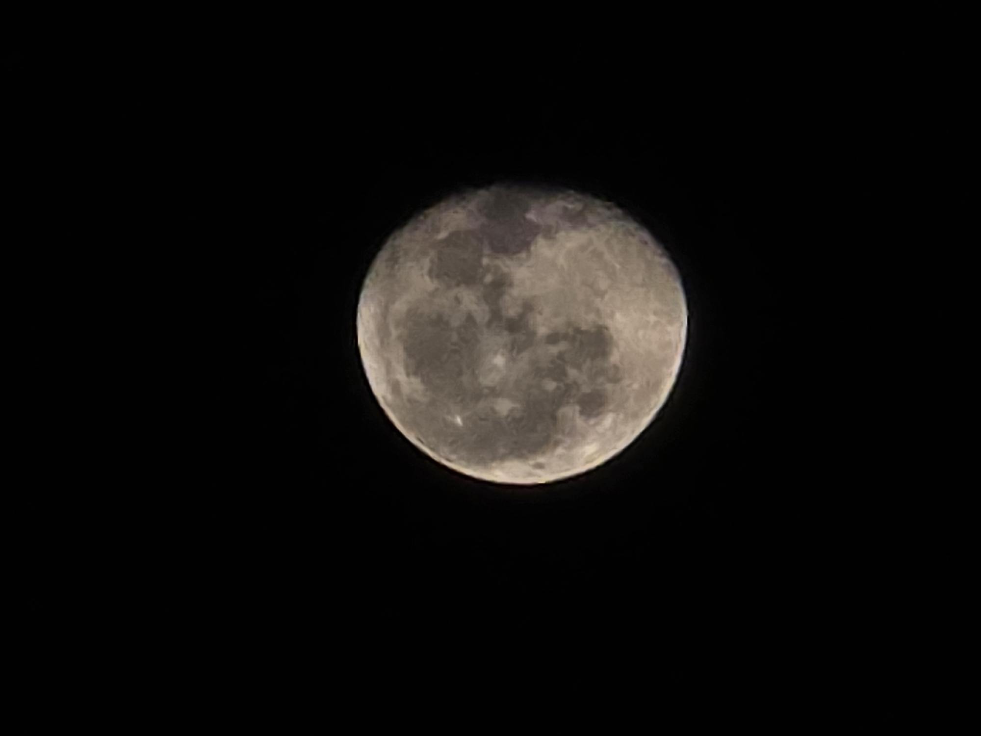 Full moon photographed over Worms, craters and light streaks visible