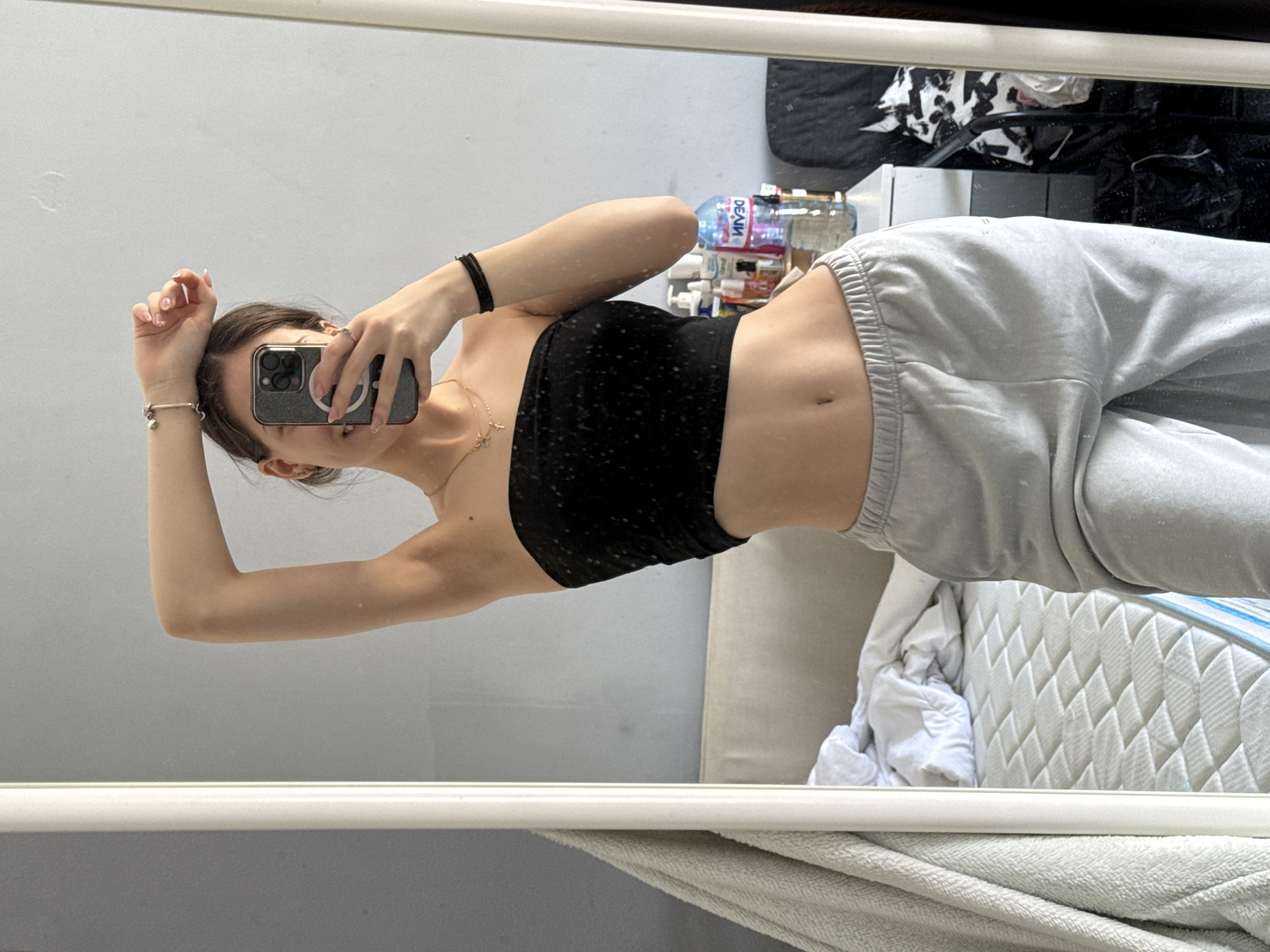 Woman takes mirror selfies with dog in Sofia apartment