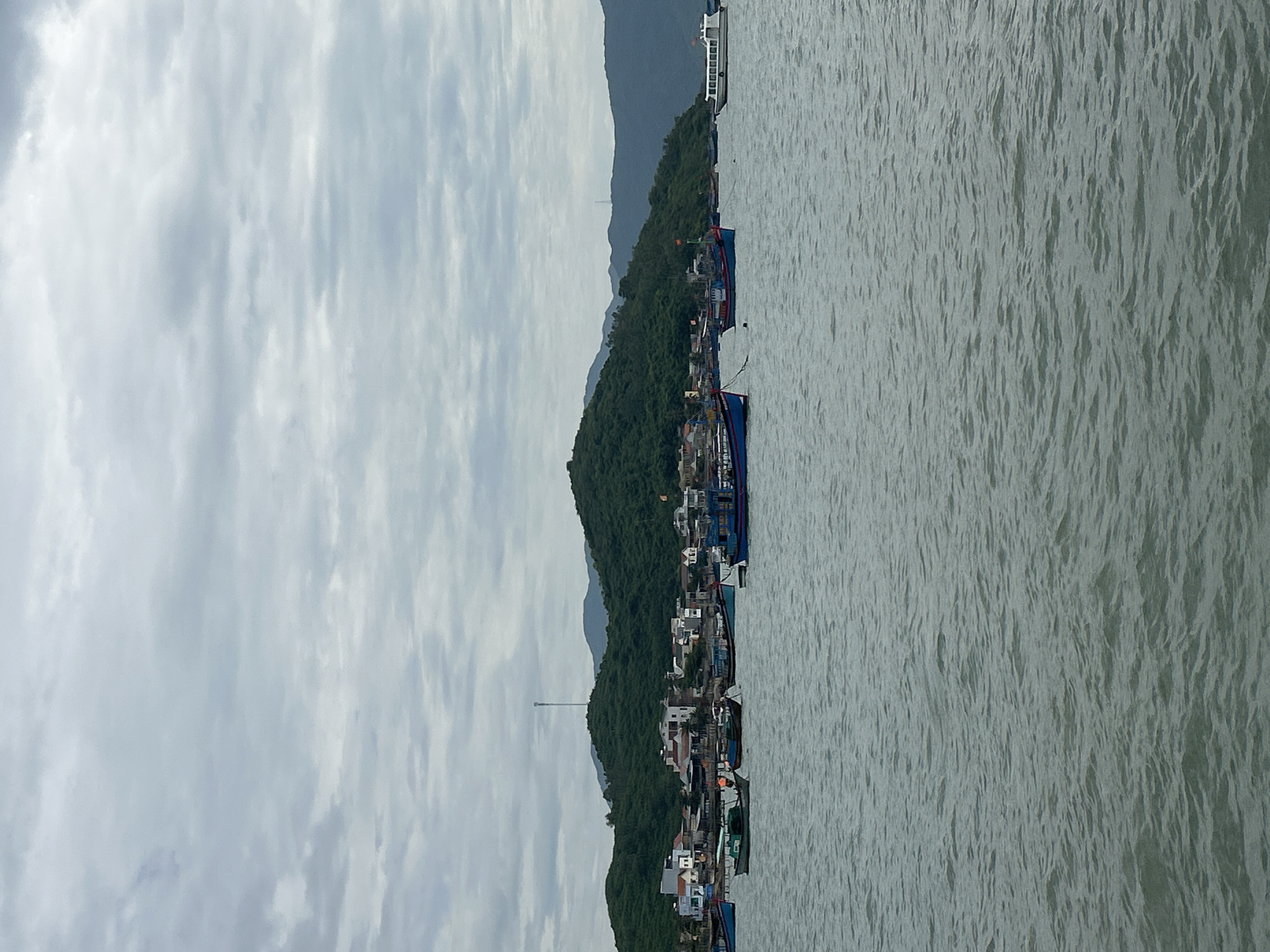 Fishing fleet anchored off the cloudy coast of Ninh Ích