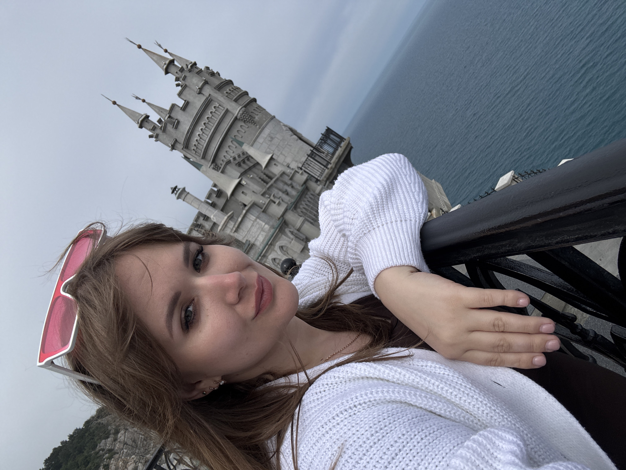 Tourist photographs Swallow's Nest castle and coastal scenery in Ukraine