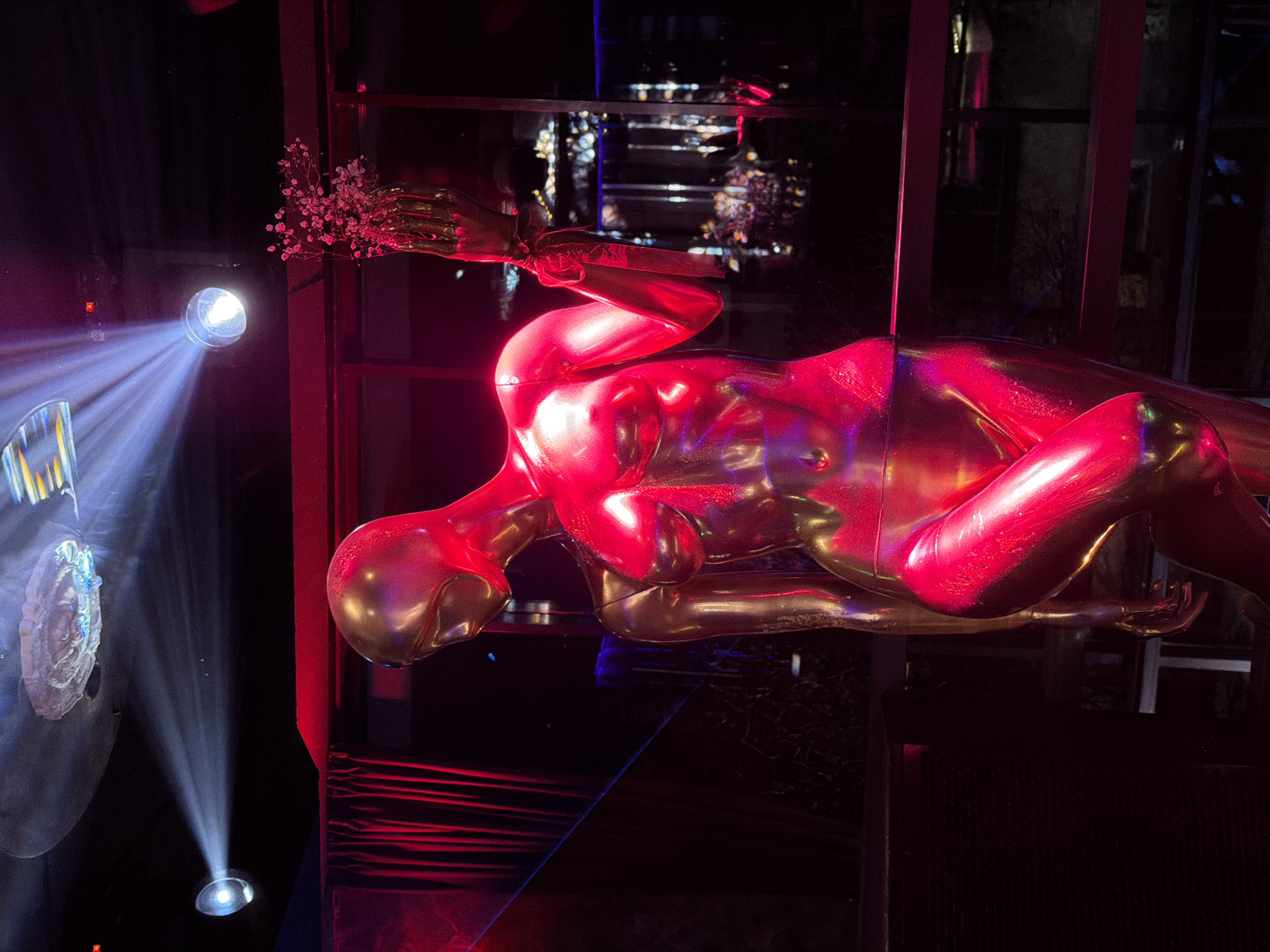 Indoor venue scenes captured: hookah smoking, suspended art figure