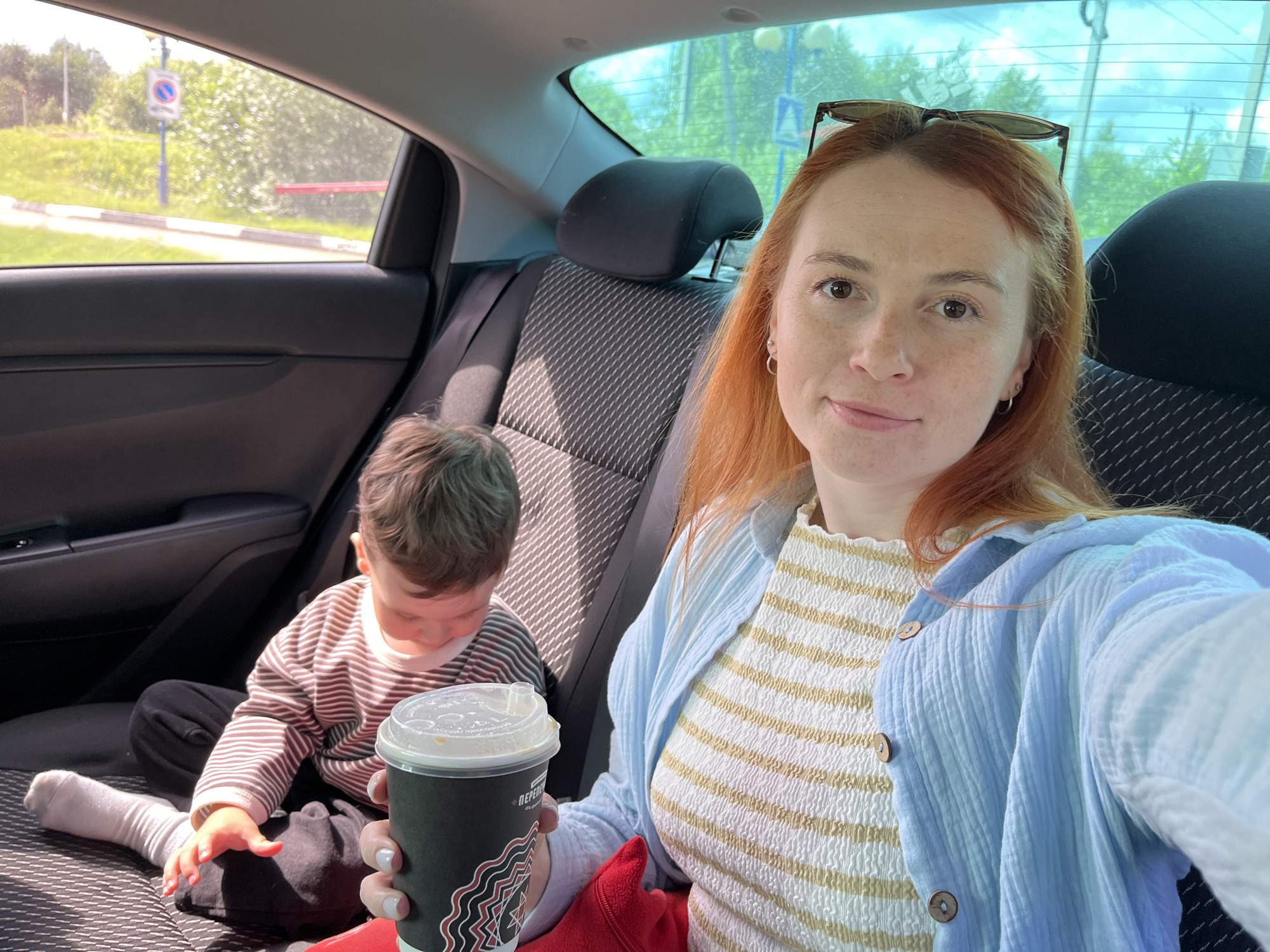 Backseat selfie with coffee, somewhere in rural Russia