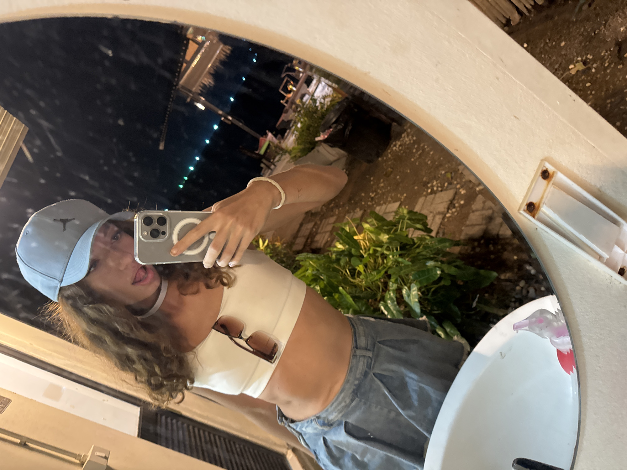 Woman takes mirror selfie in Baan Bang Rak, Thailand