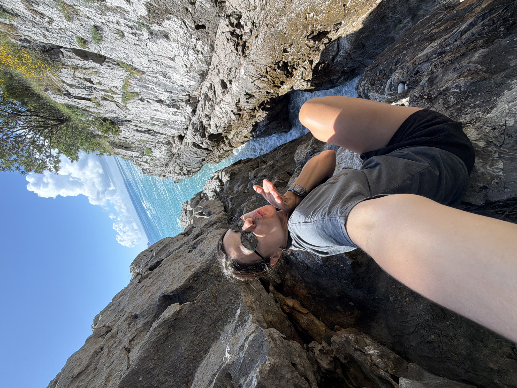 Woman documents coastal exploration at Montenegro cliffs during morning visit