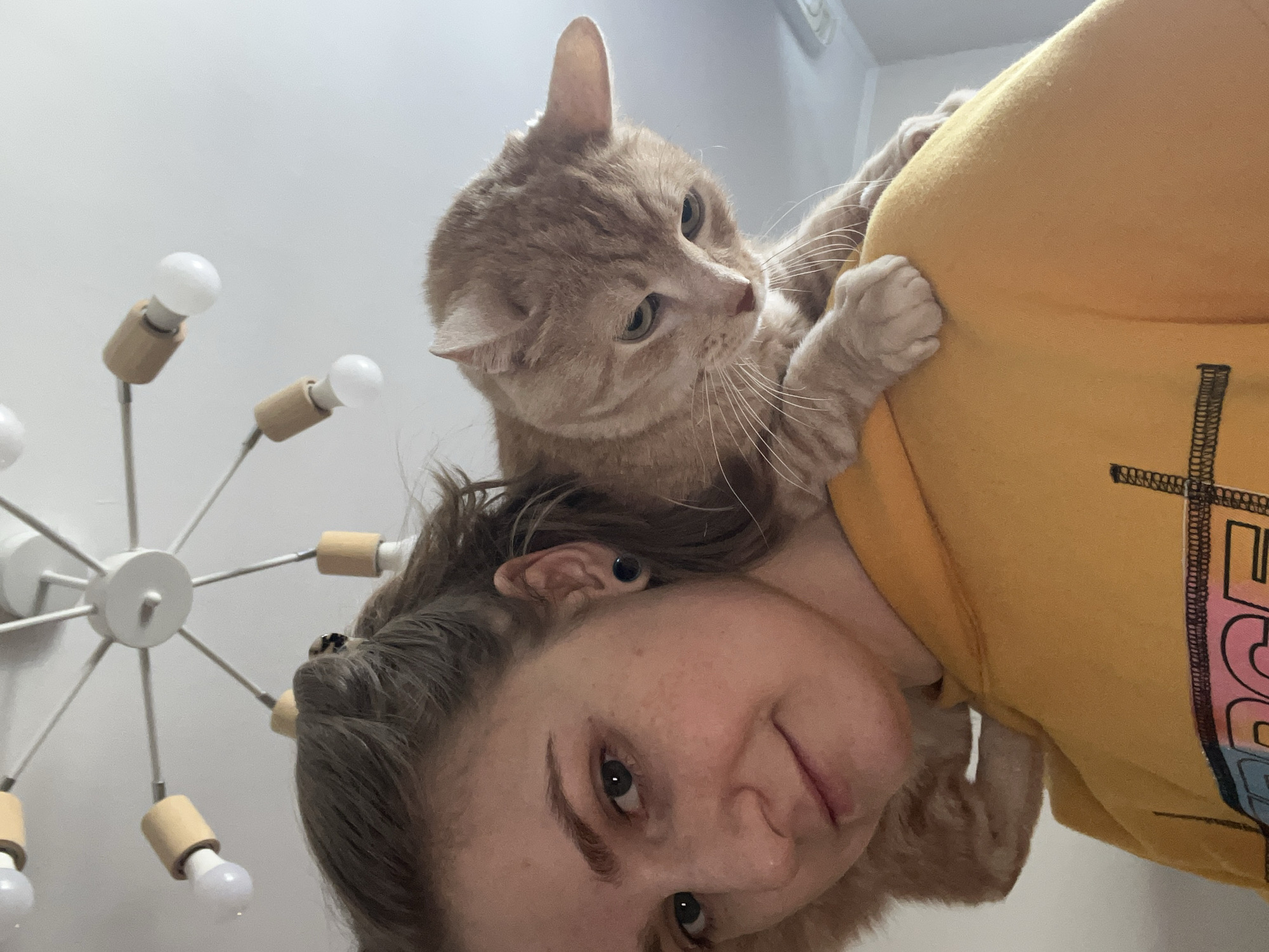 Woman and orange cat share quiet moment in Novosibirsk