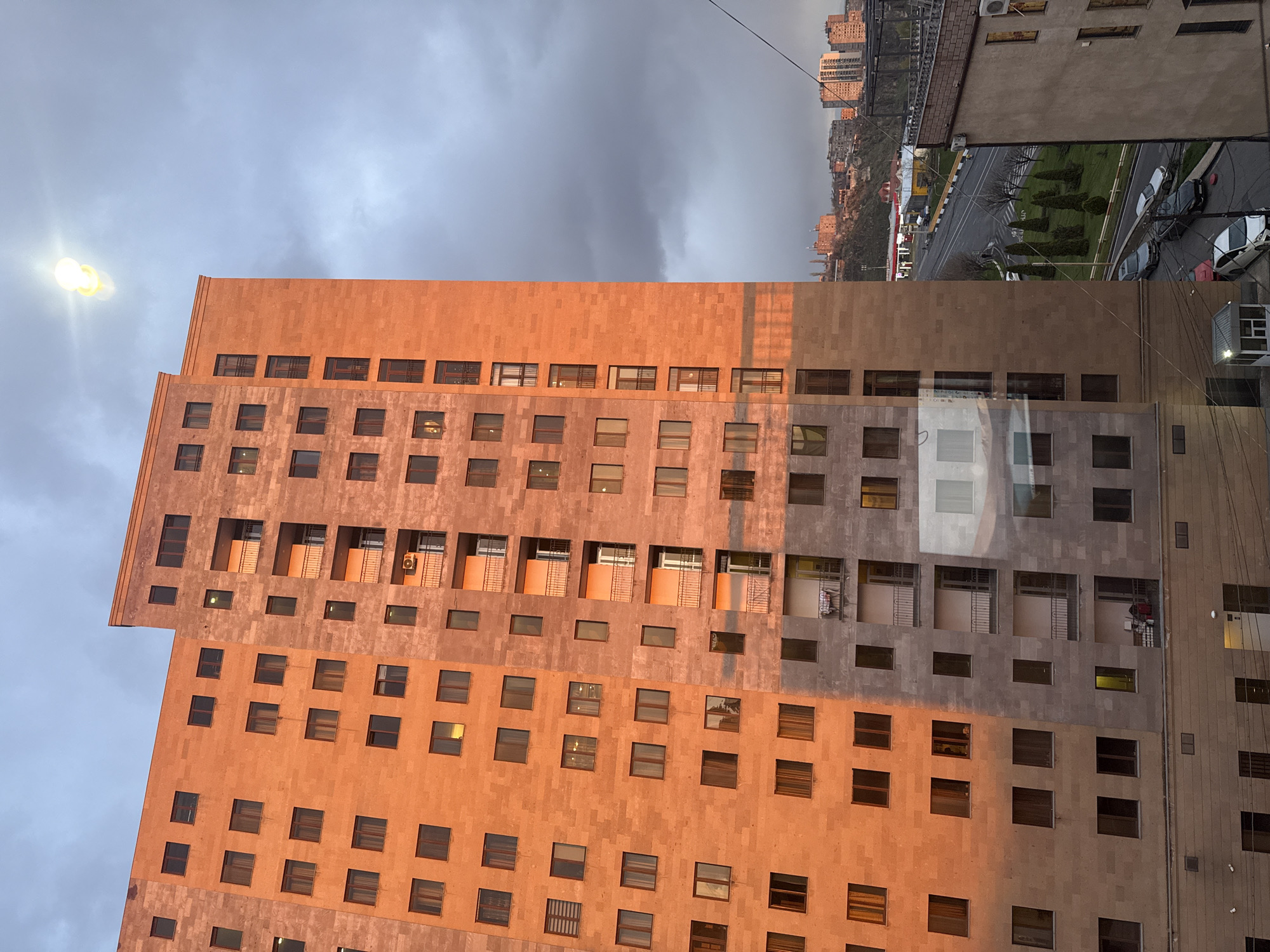 Stone facade building with orange-gray blocks documented in Yerevan