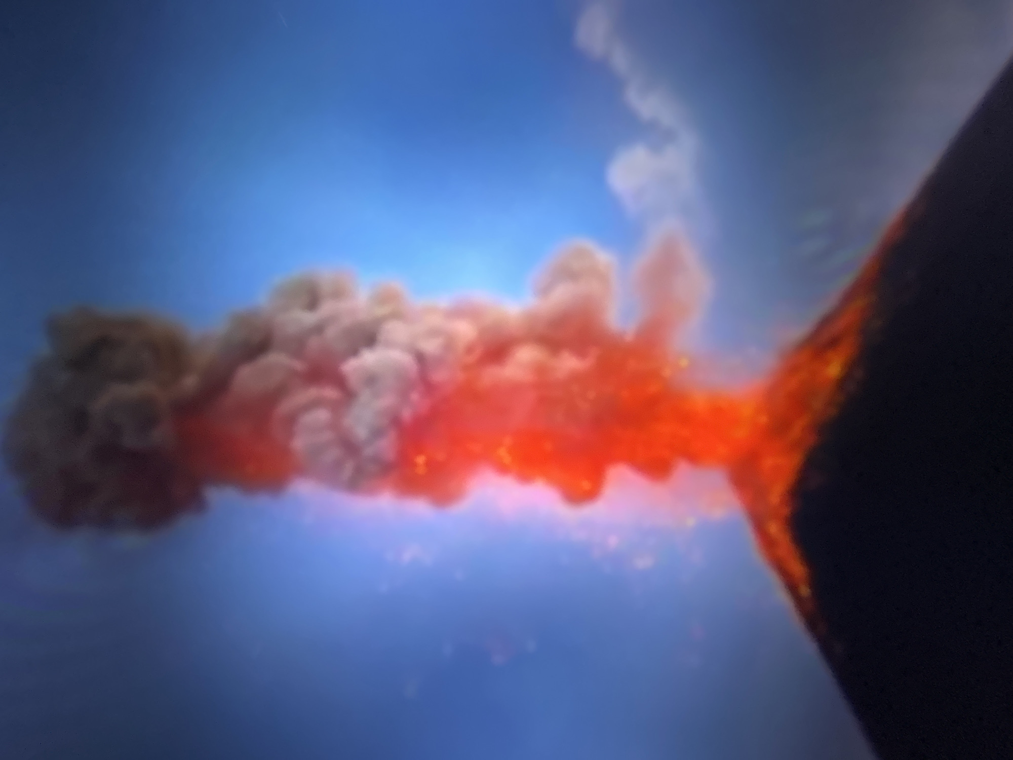 Active volcano erupts with glowing lava flows down its slopes