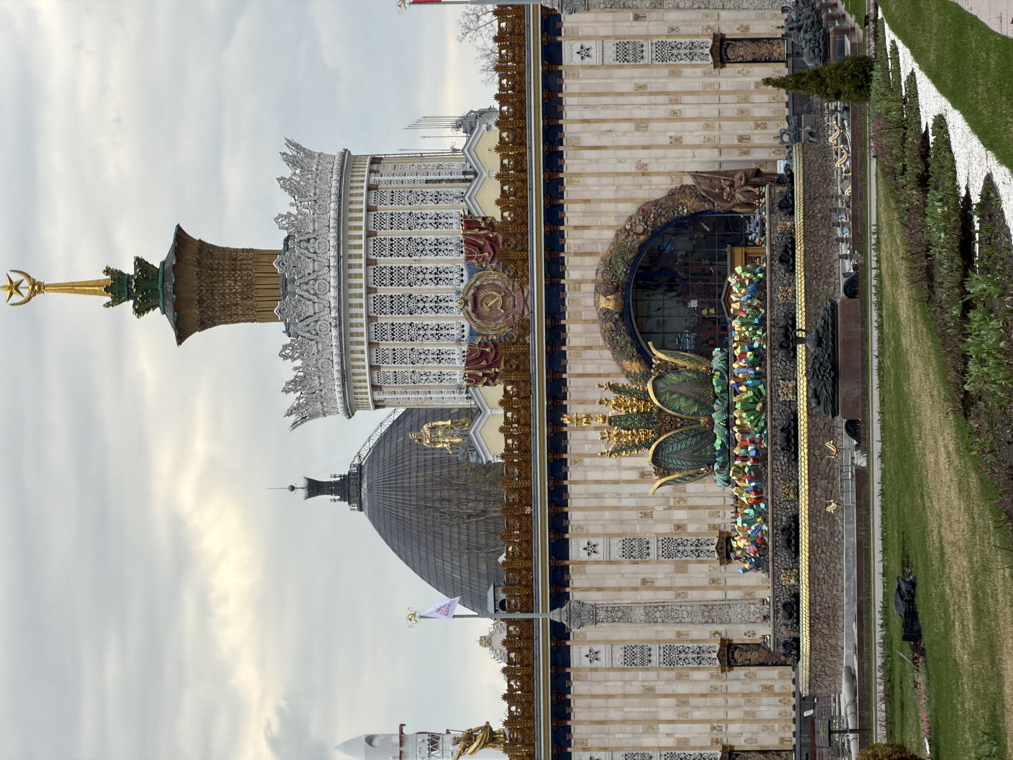 Moscow exhibition pavilions with golden spire captured under overcast sky