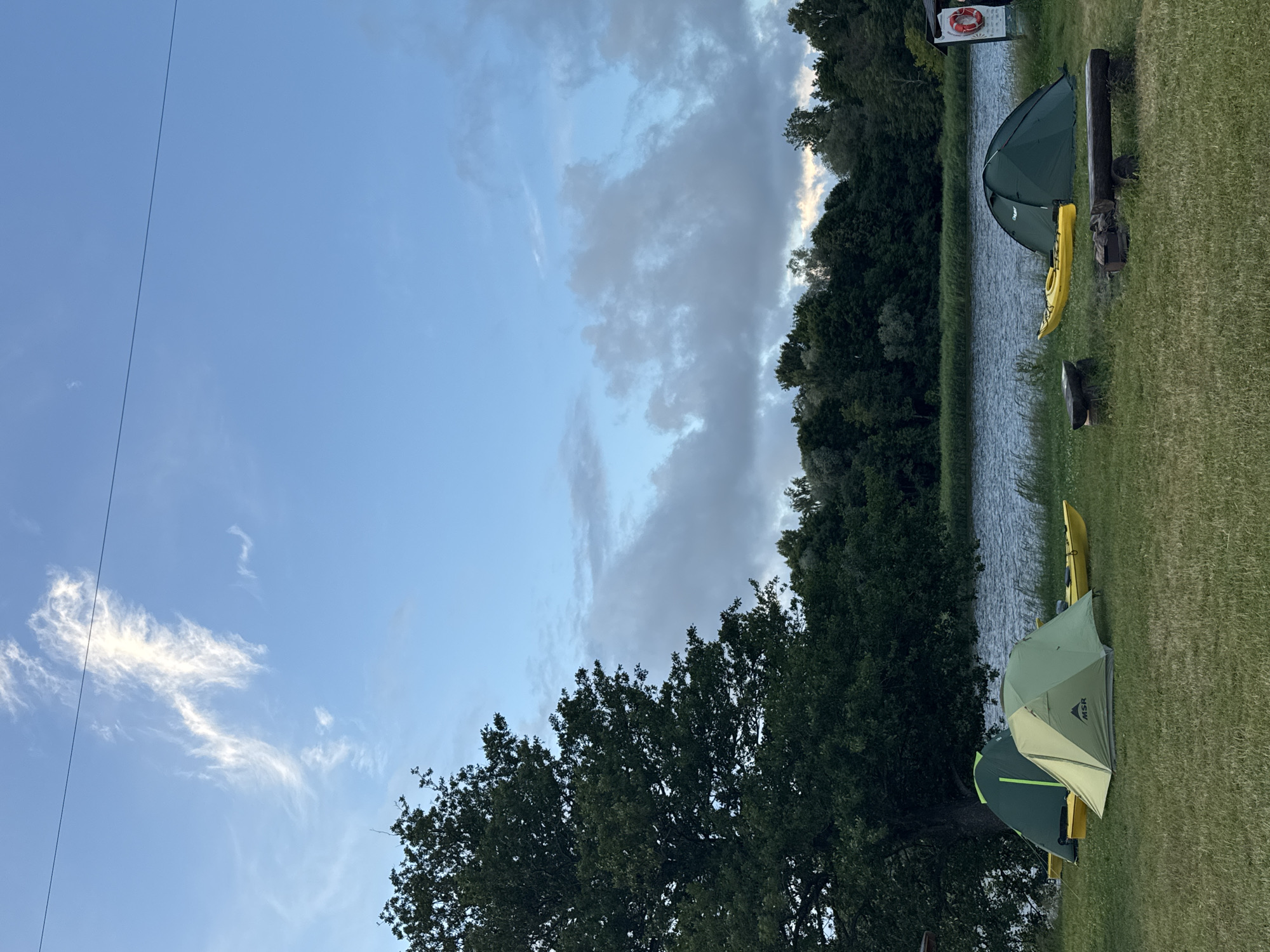 Camping and kite flying by the Gauja River at dusk