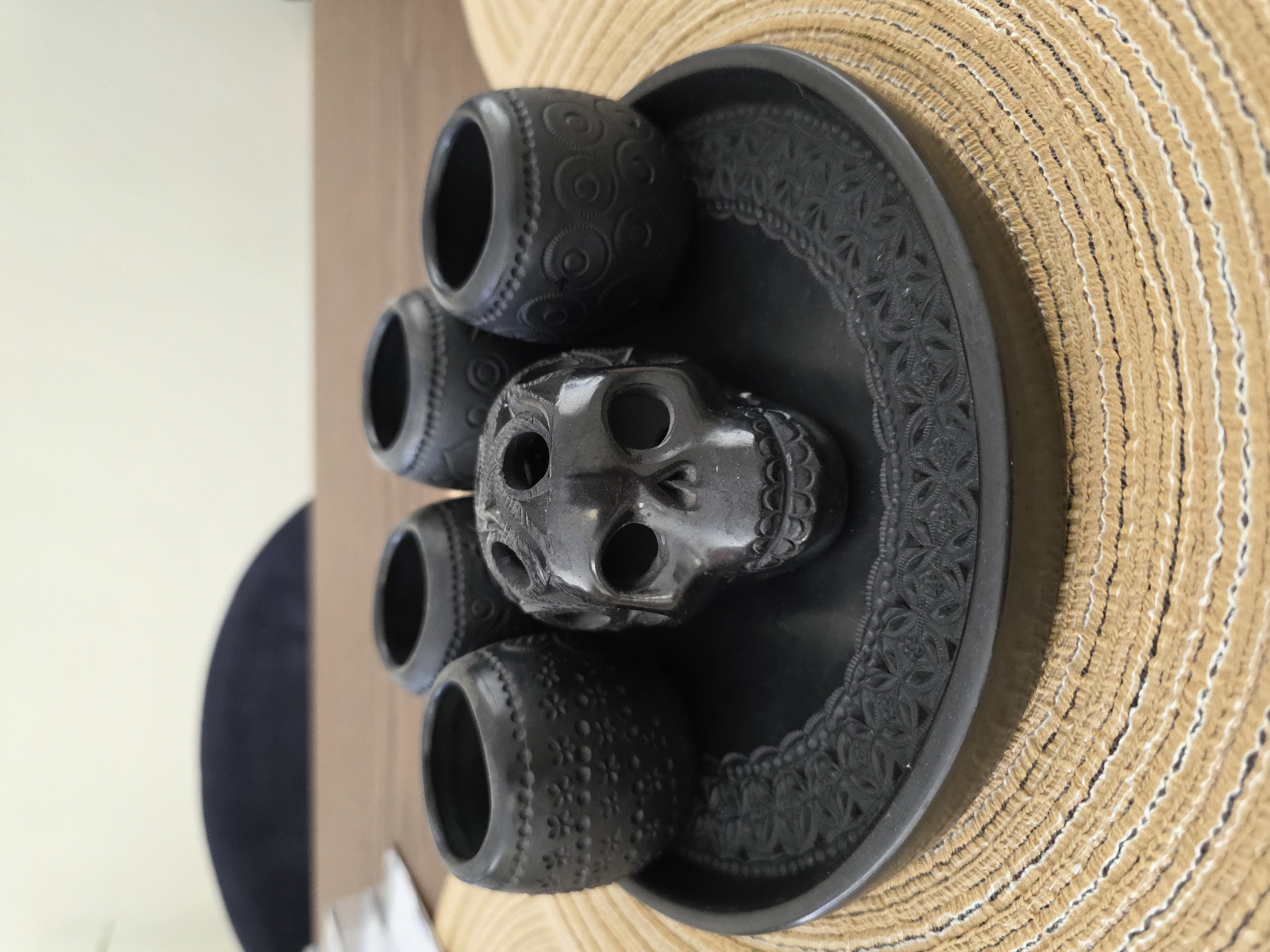 Black ceramic skull and vessels displayed in Puebla home