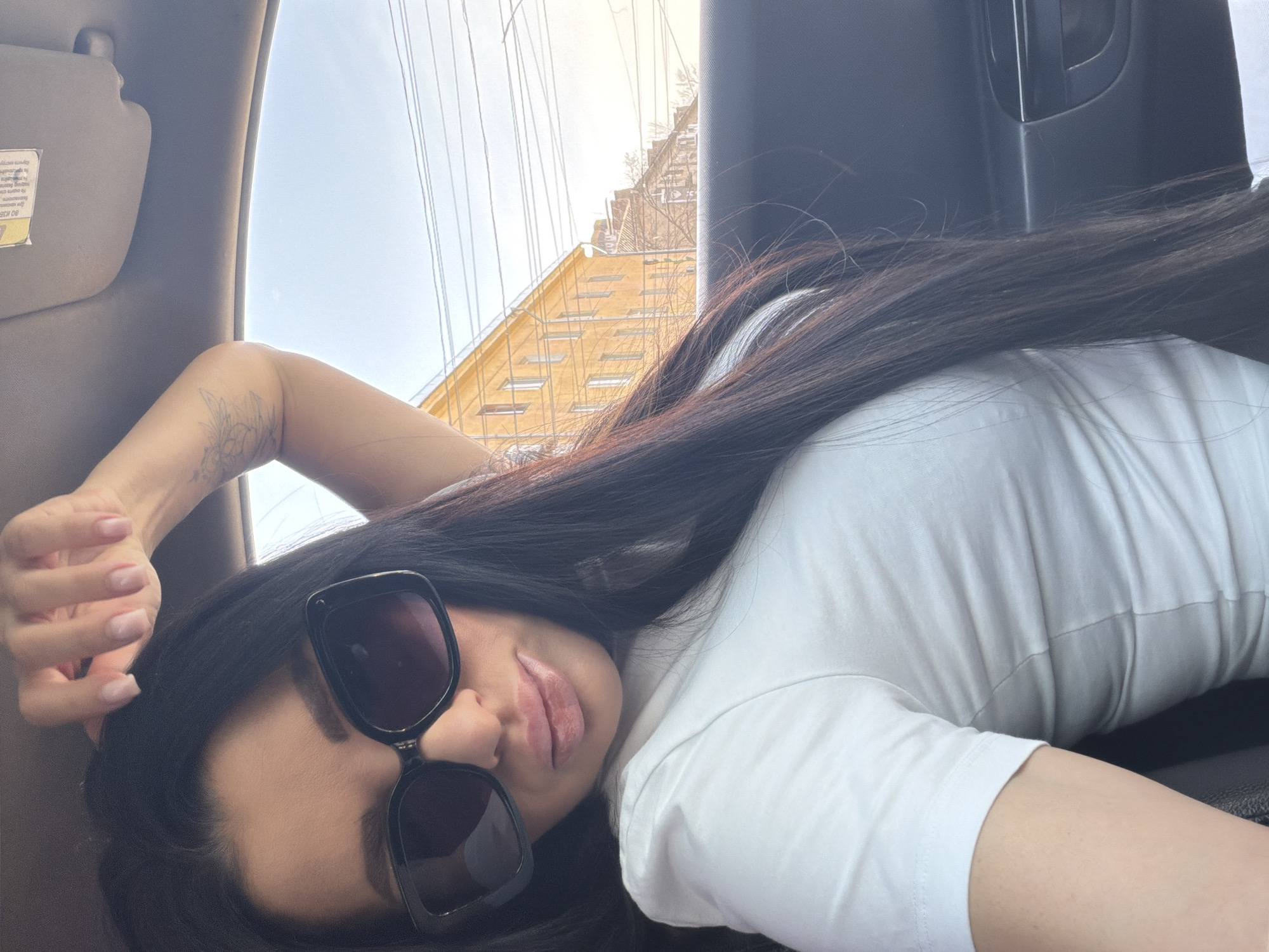 Woman rests in car near construction site in Voronezh