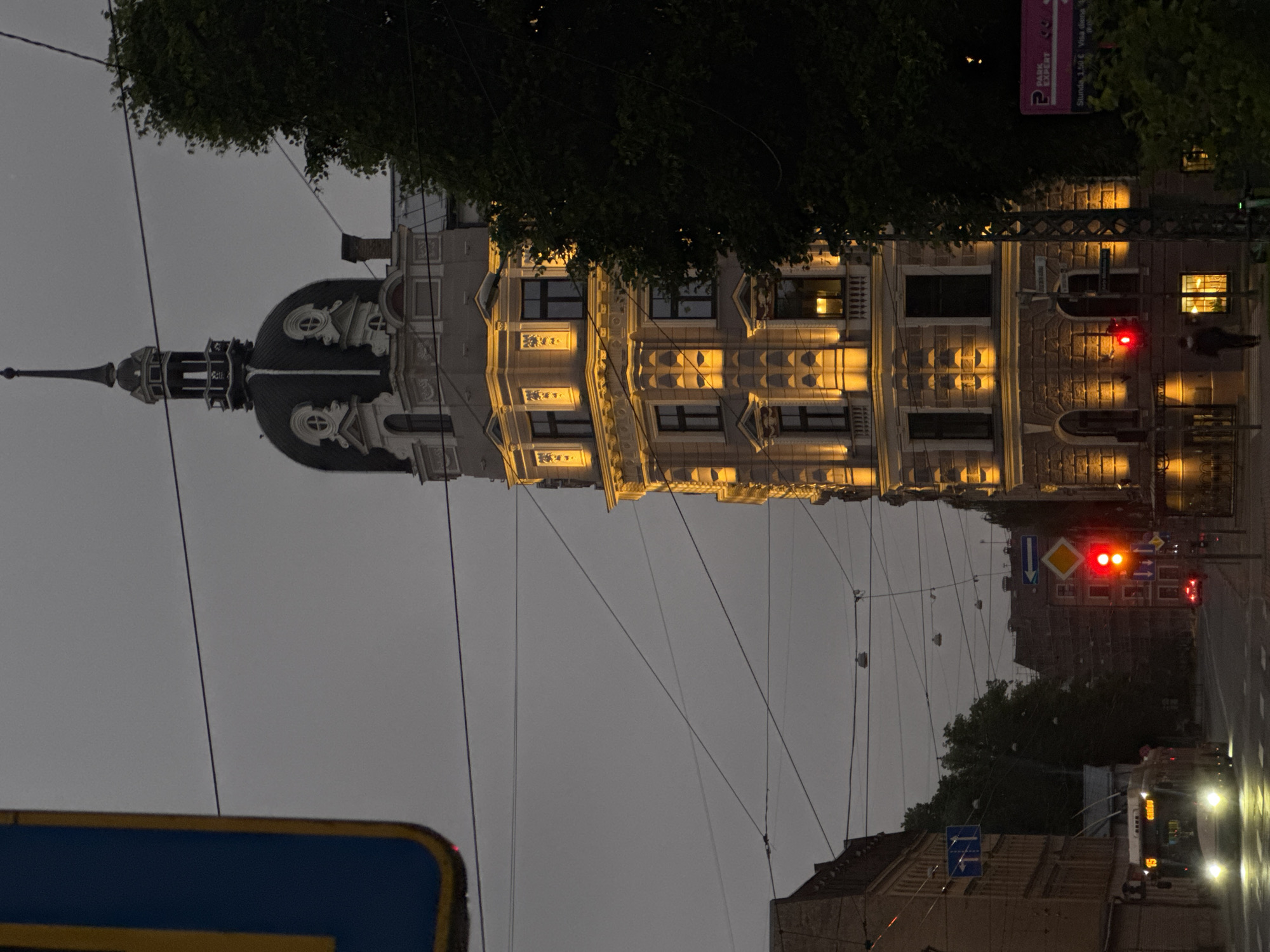 Riga street corner at dusk, Ģertrūdes church tower in view