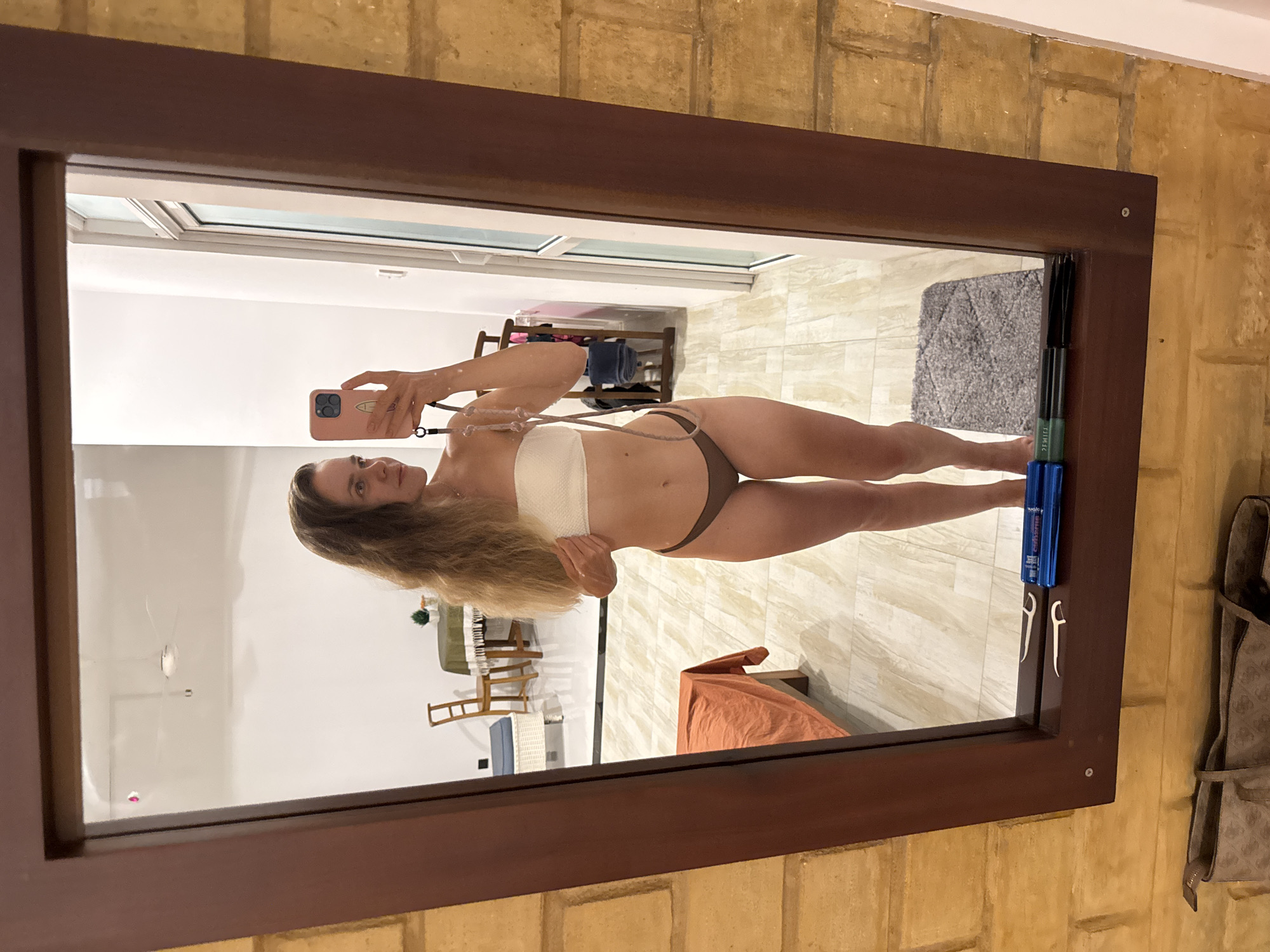 Woman takes mirror selfie in beige bikini, Thalaramba