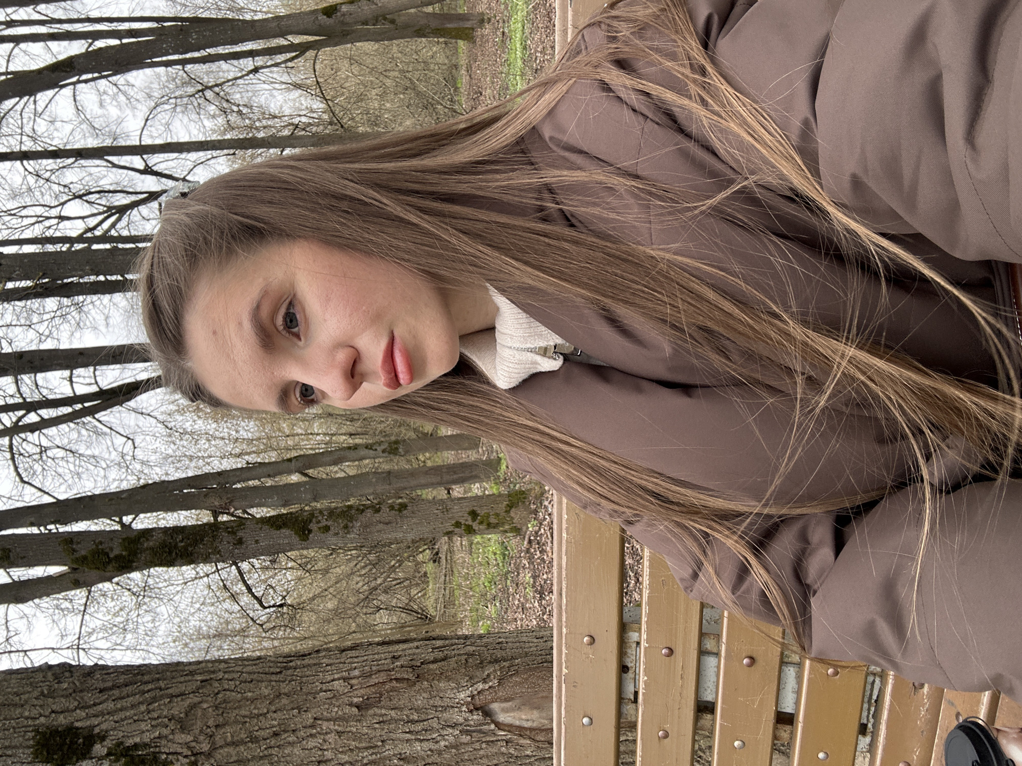 Woman walks dog during morning coffee break in Klin park