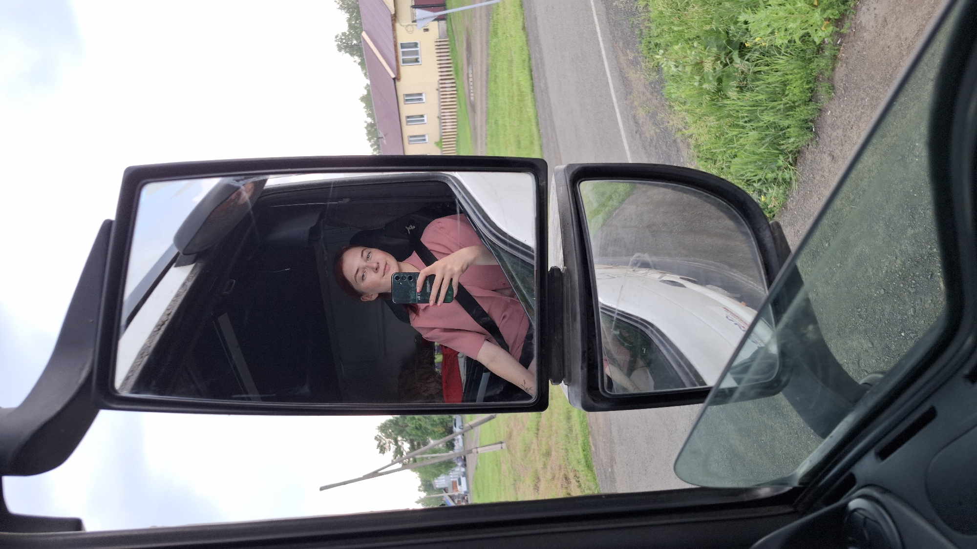 Truck cab selfie and rural road scene in Nizhny Ingash