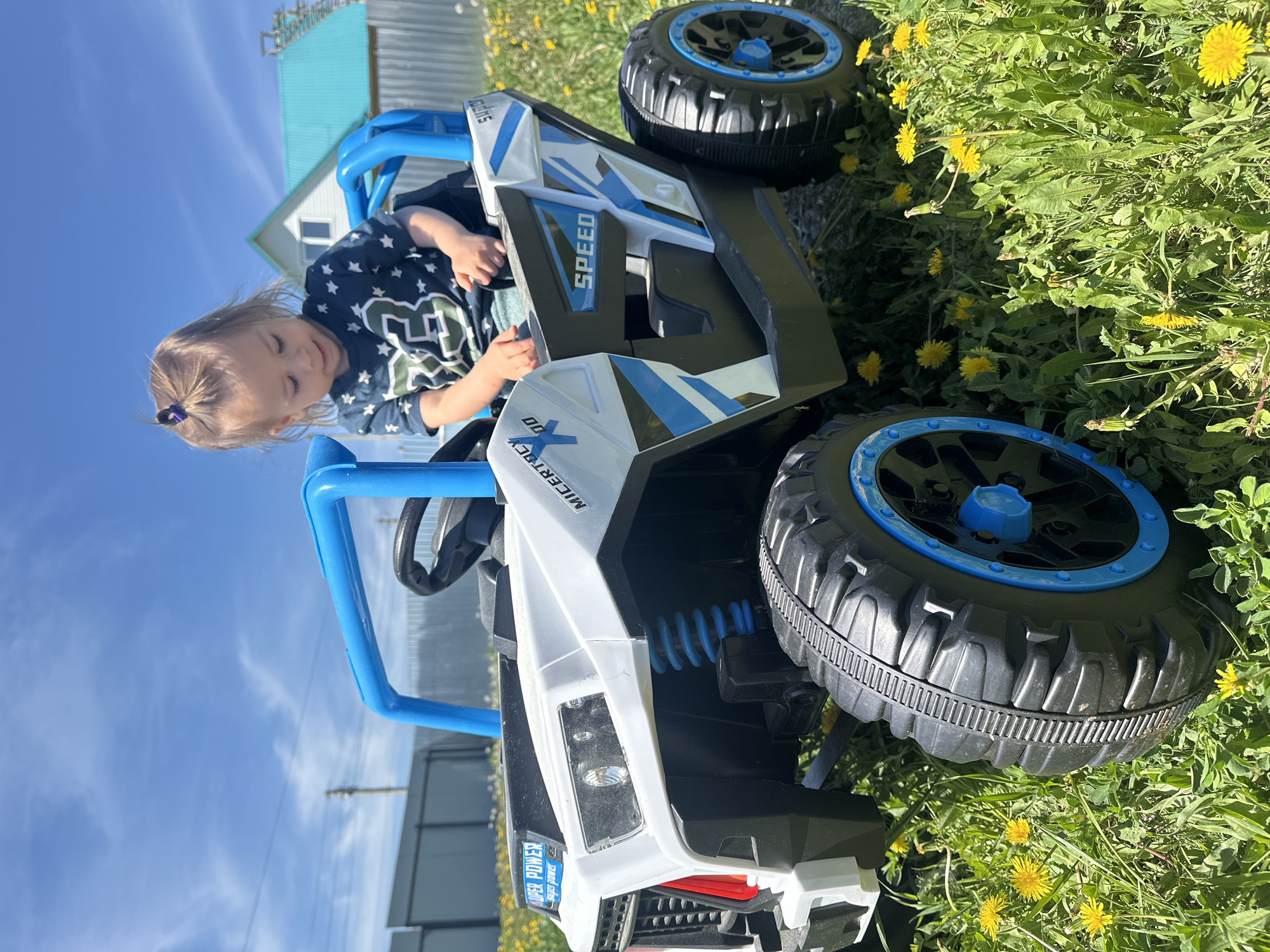 Child plays with toy vehicle in Russian garden