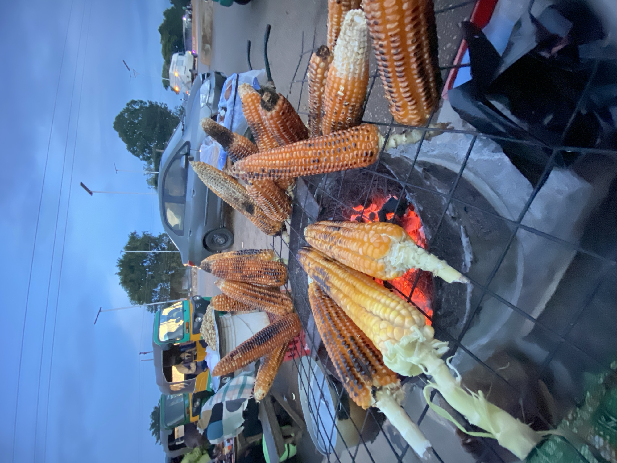 Roasted corn and fresh fruit at a Bukuru roadside stand