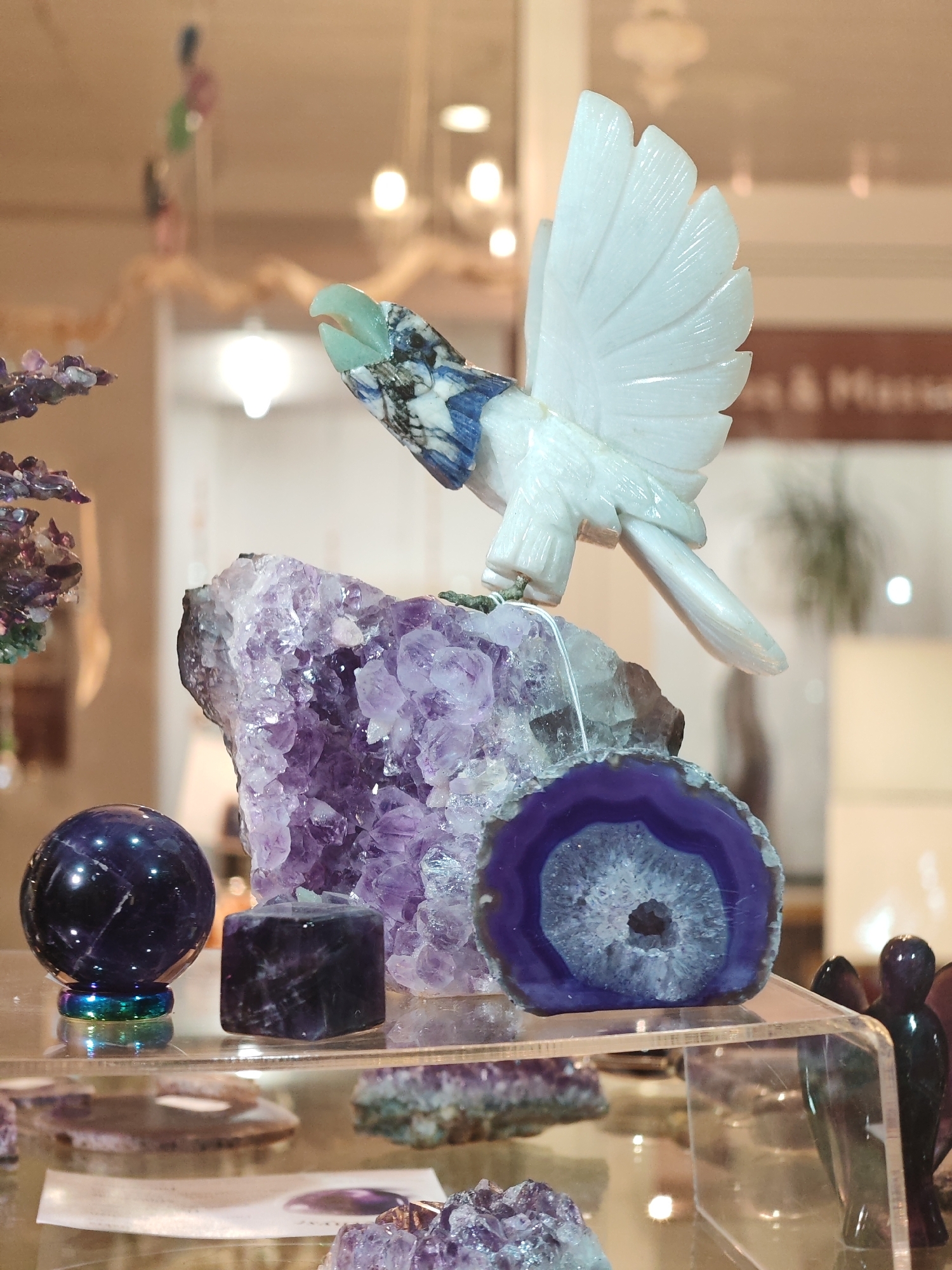 Inside a crystal shop: carved stones, geodes, and gemstone bottles