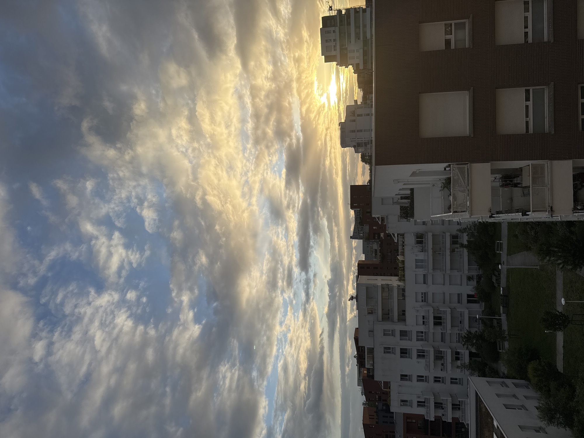 Dramatic sunset illuminates clouds over Toulouse cityscape