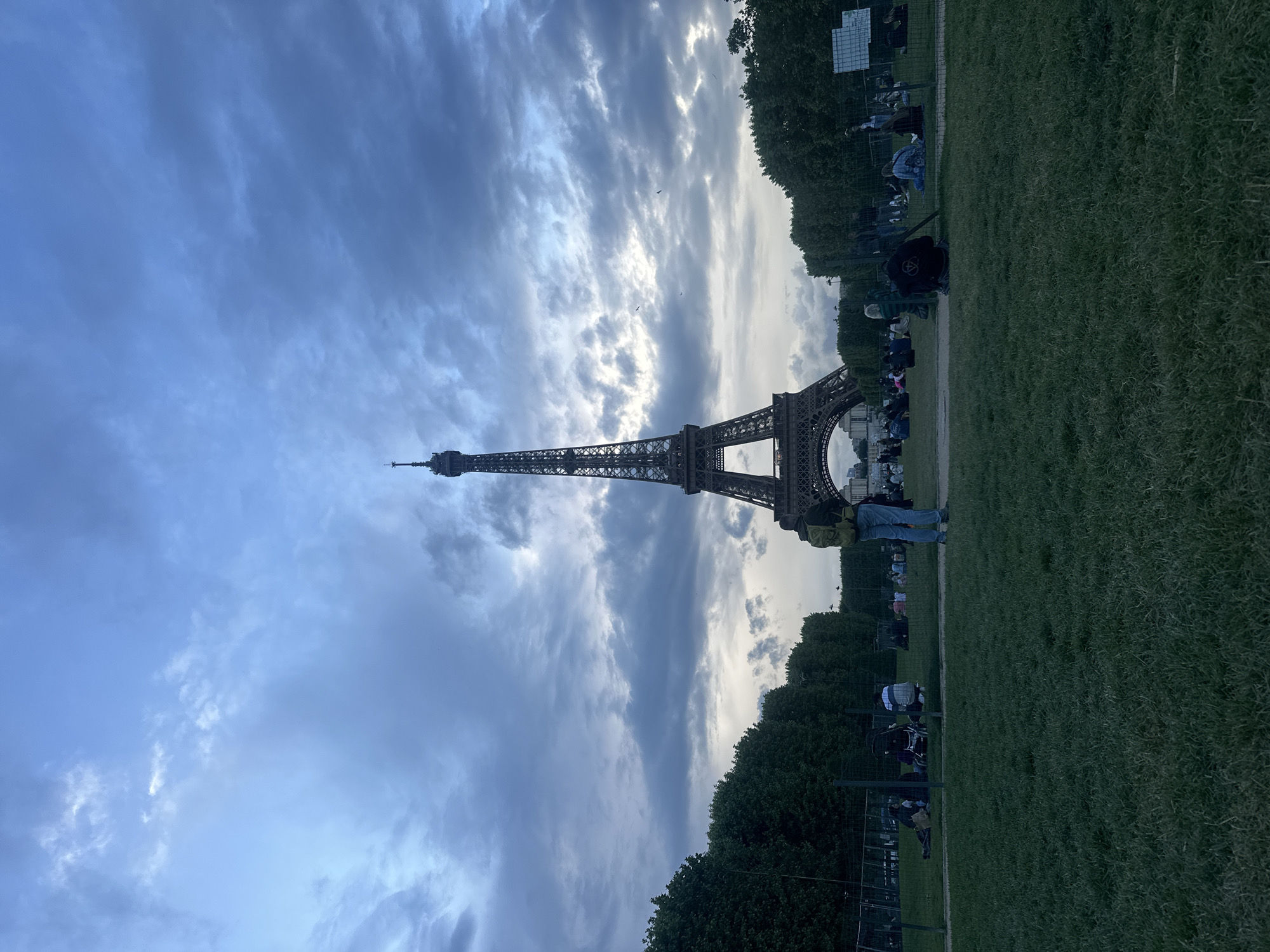 Person walks across Eiffel Tower lawn in Paris