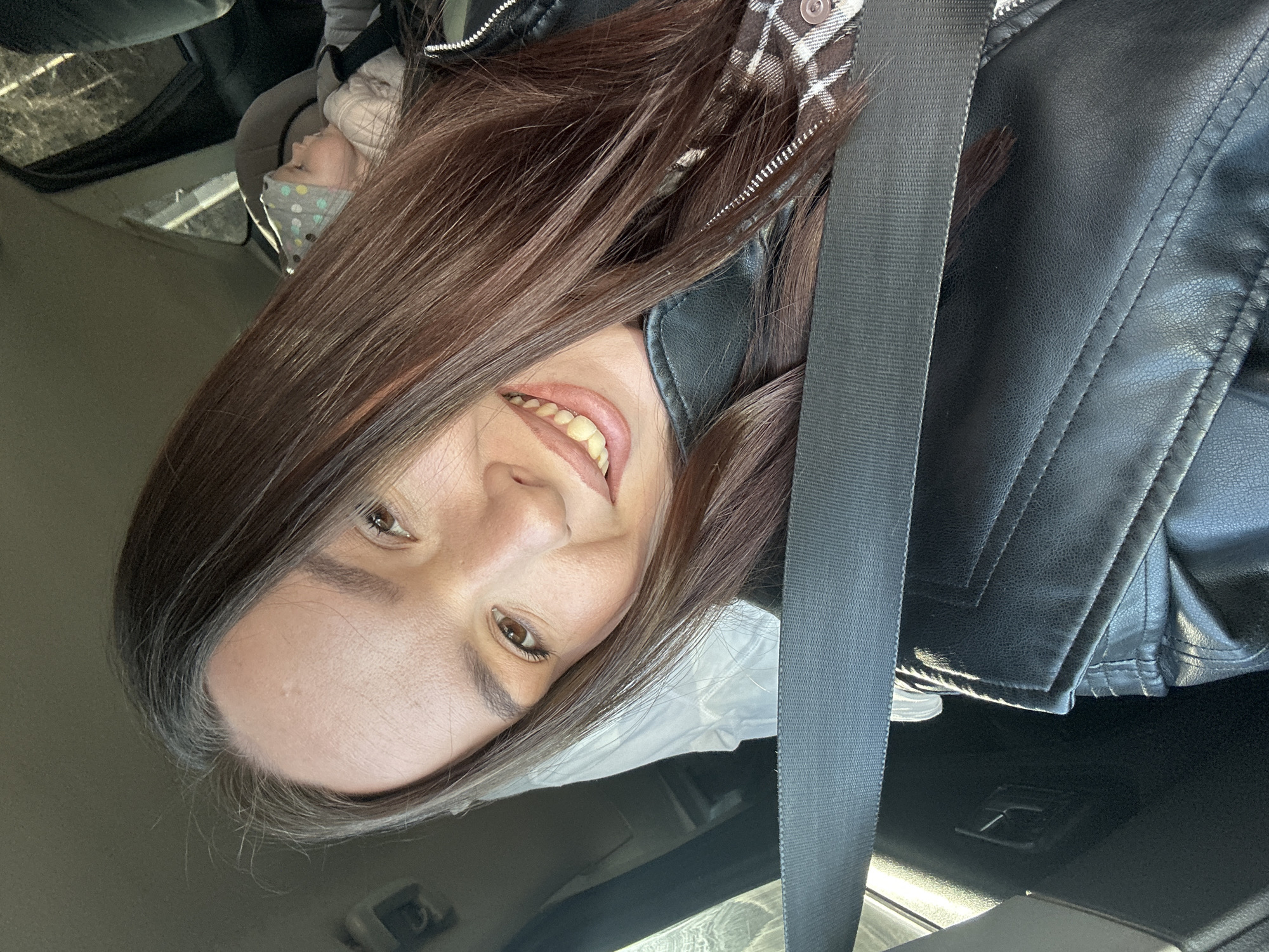 Woman and child photographed in car in Chaikovsky, Russia