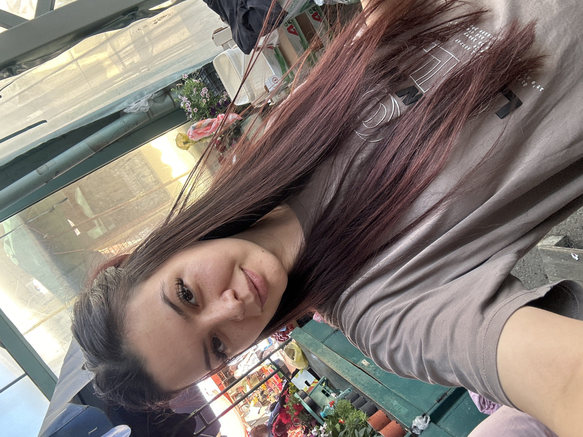 Woman takes morning selfies at Sliven marketplace greenhouse