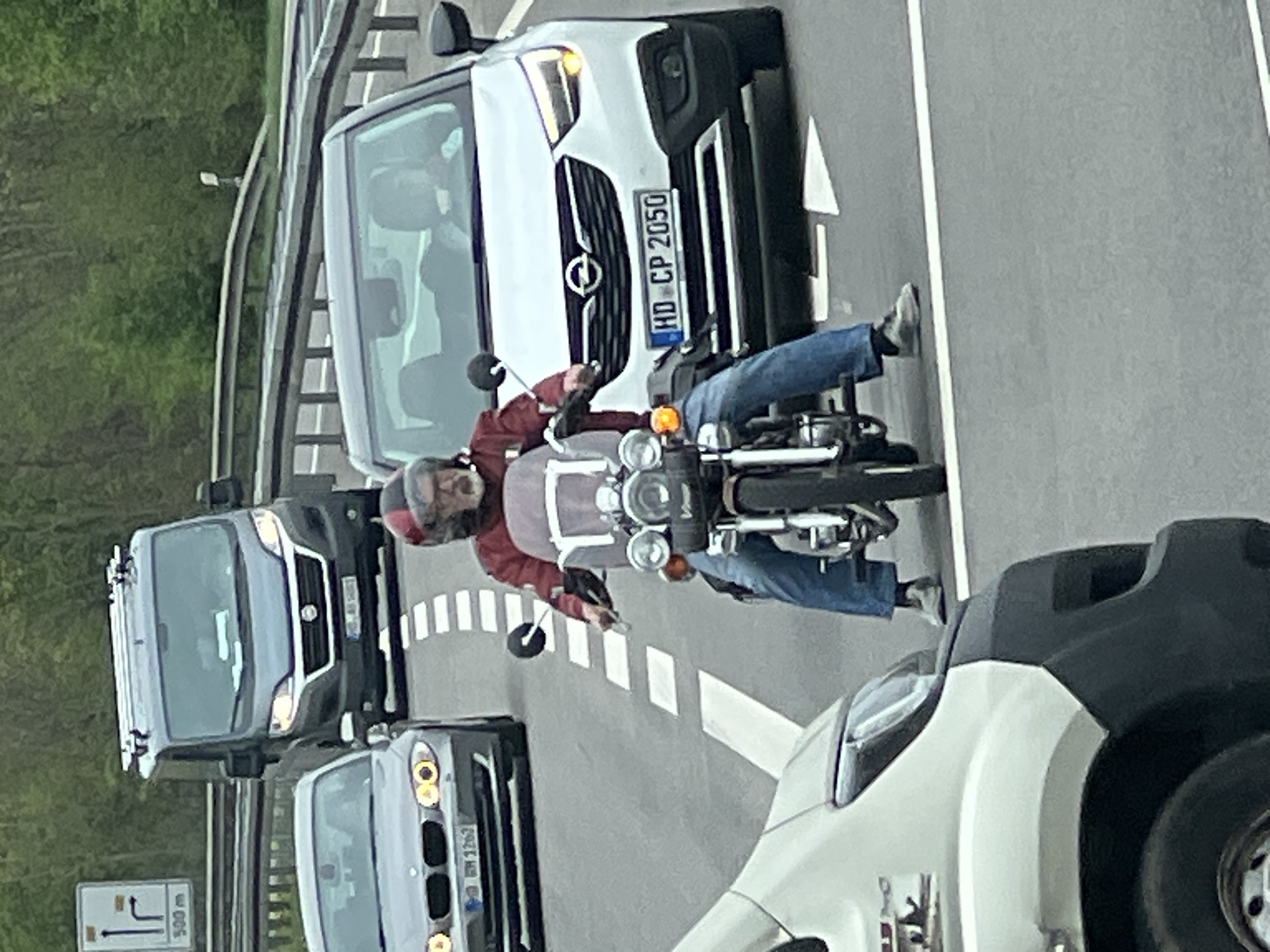 Motorcyclist in red jacket observed riding in traffic