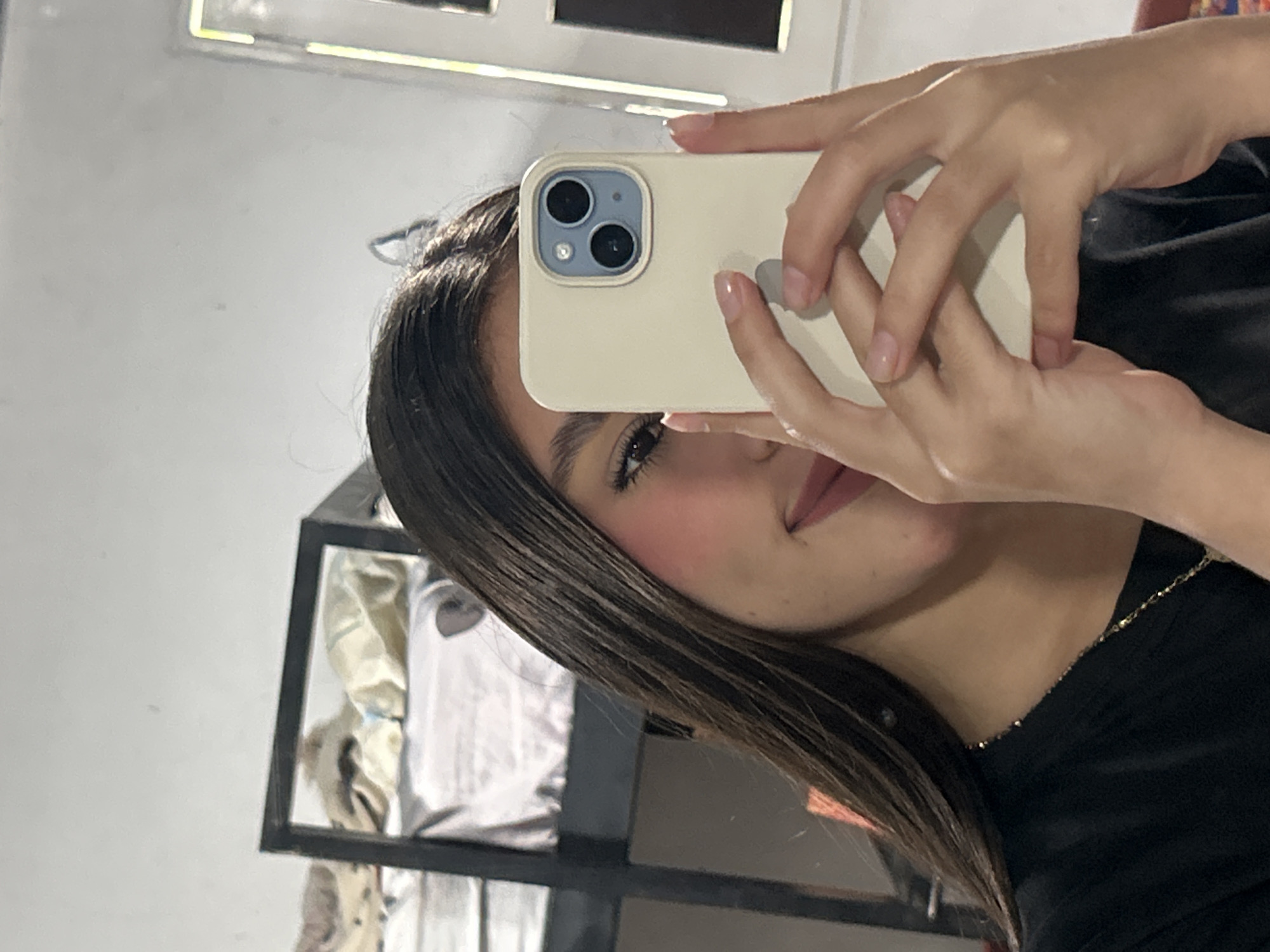 Mirror selfie in a Juan Griego bedroom, July 2026