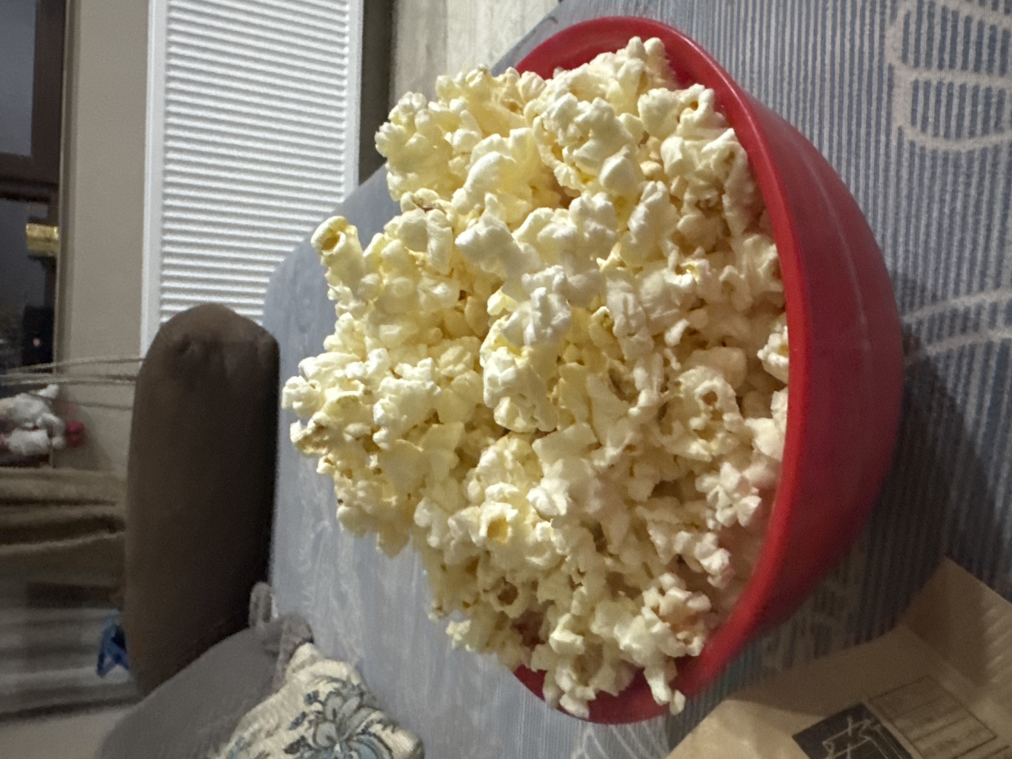 Overflowing popcorn bowl captured on couch in Lehchevo, Bulgaria