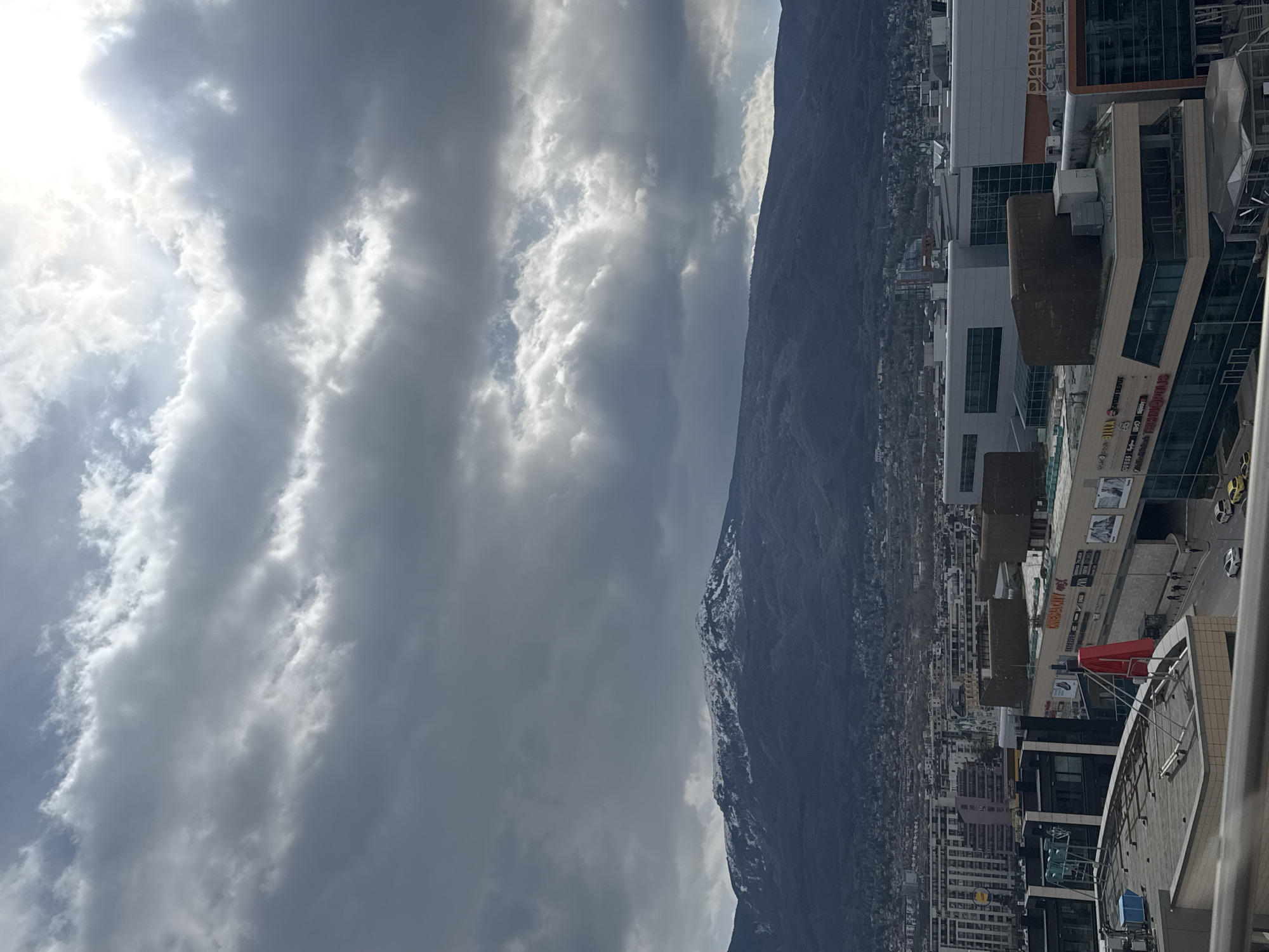 Man takes rooftop selfies overlooking Sofia cityscape