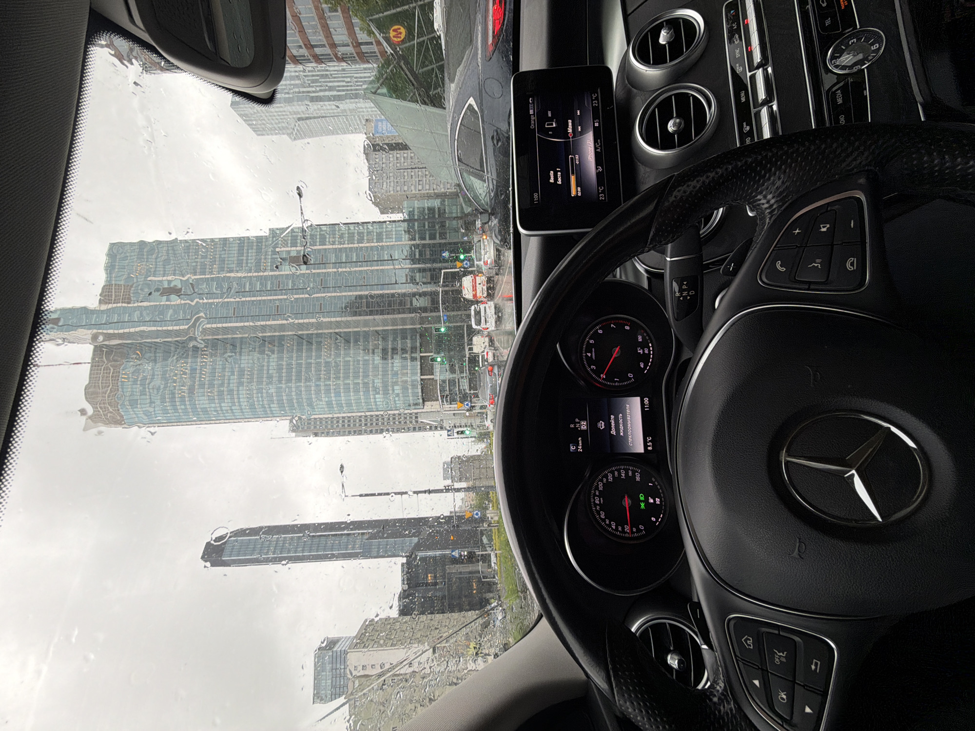 Rainy morning traffic captured from Mercedes in modern city