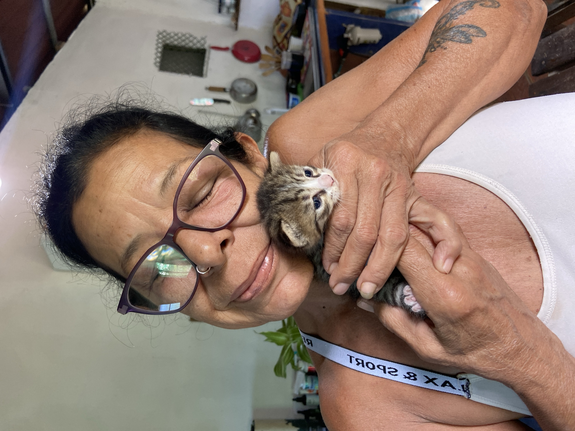 Woman holds kitten in Los Velásquez, Venezuela