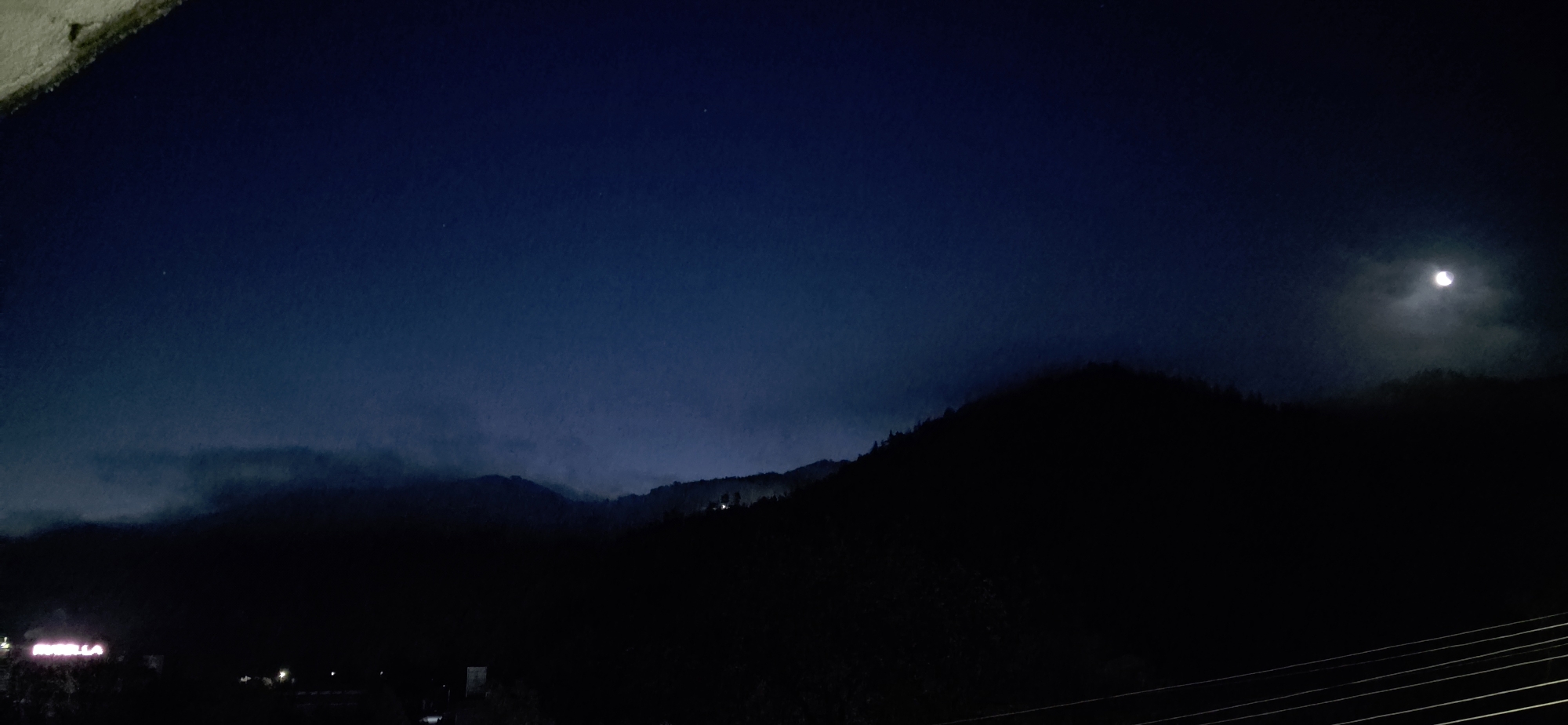 Moonlit mountain silhouettes observed in Rudozem, Bulgaria at night