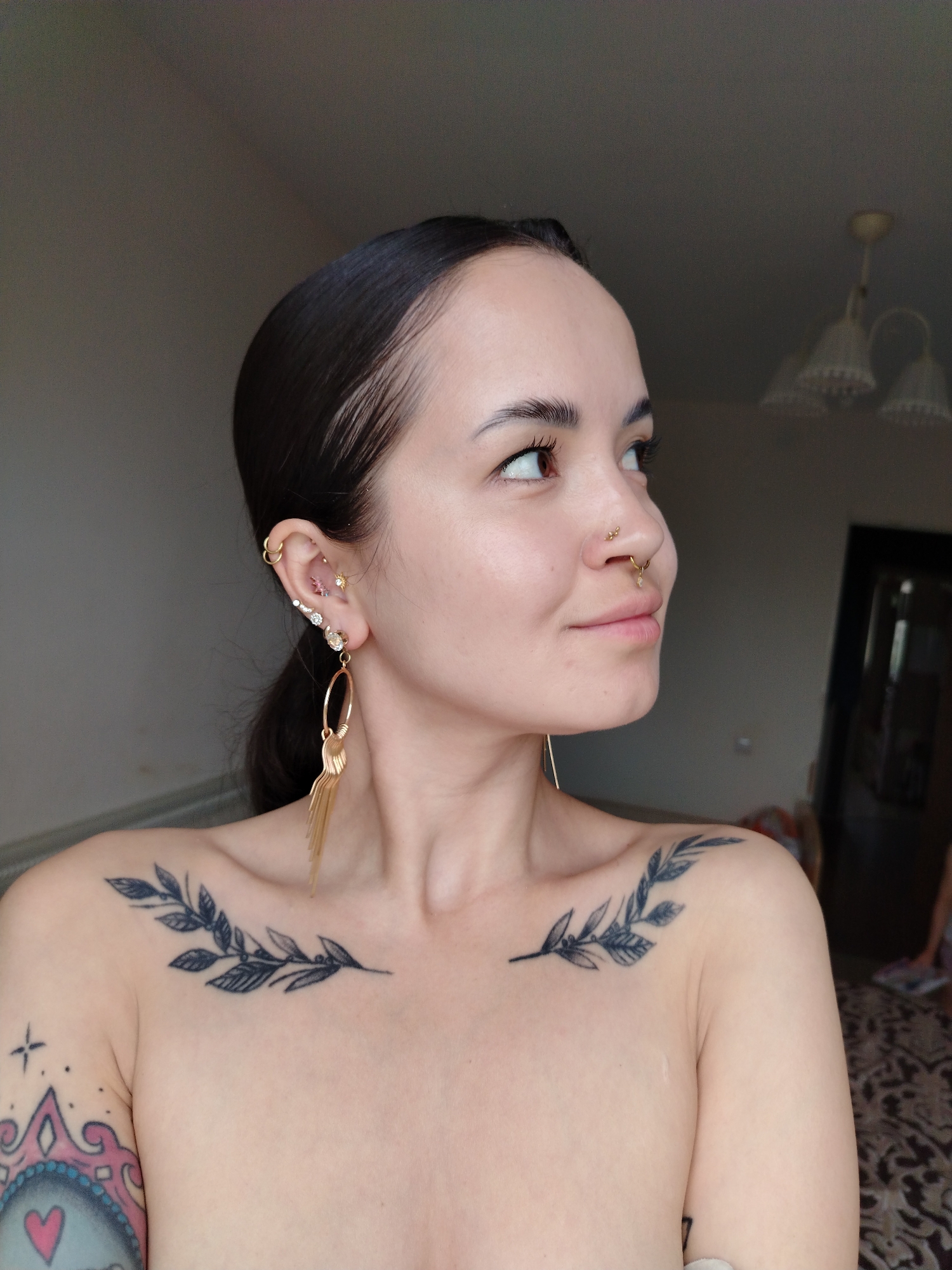 Woman with piercings and tattoos photographed in Noviy, Russia