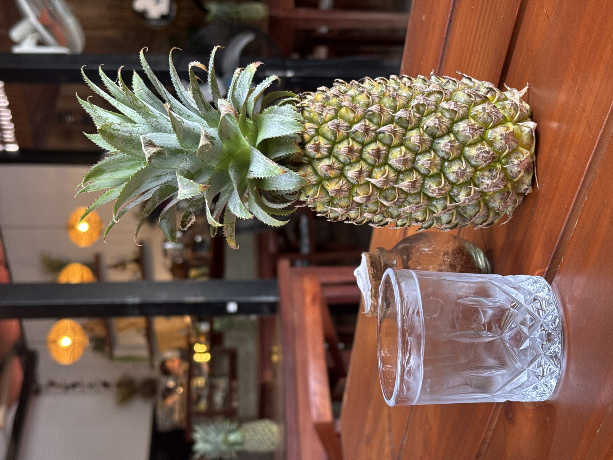 Pineapple and water on a wooden table in Siem Reap