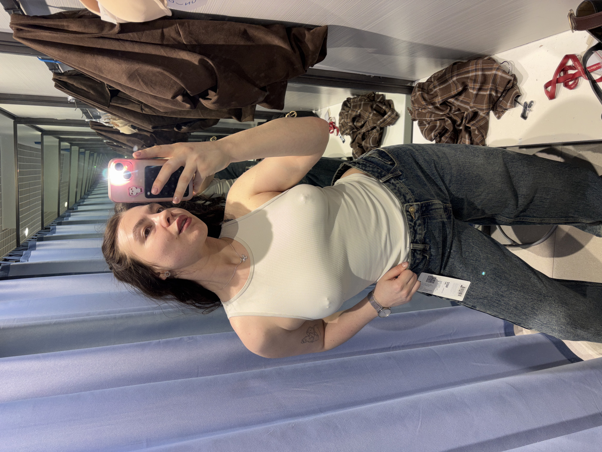 Woman tries on clothes in Perm store fitting room