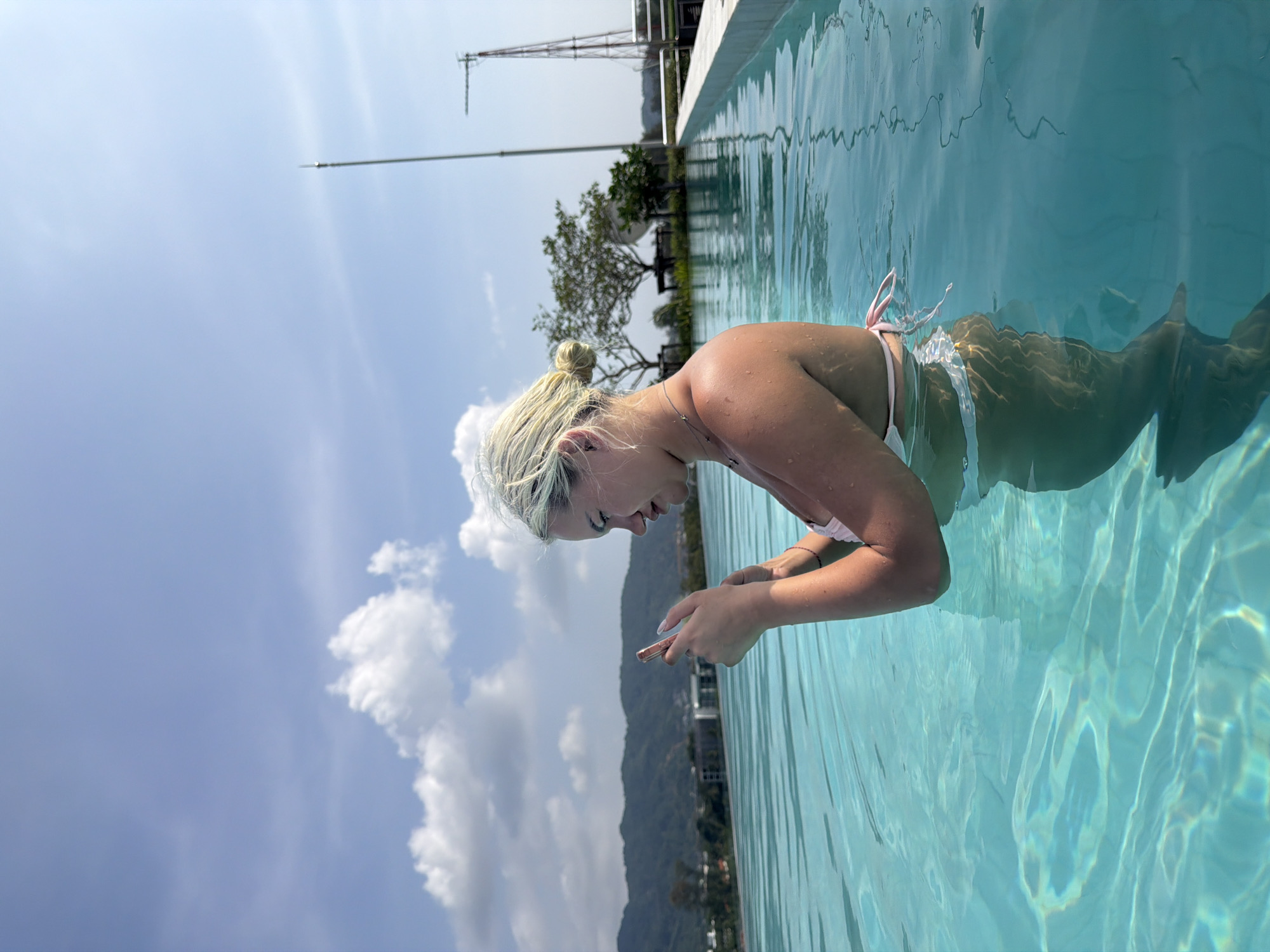 Woman enjoys morning swim in Thailand infinity pool