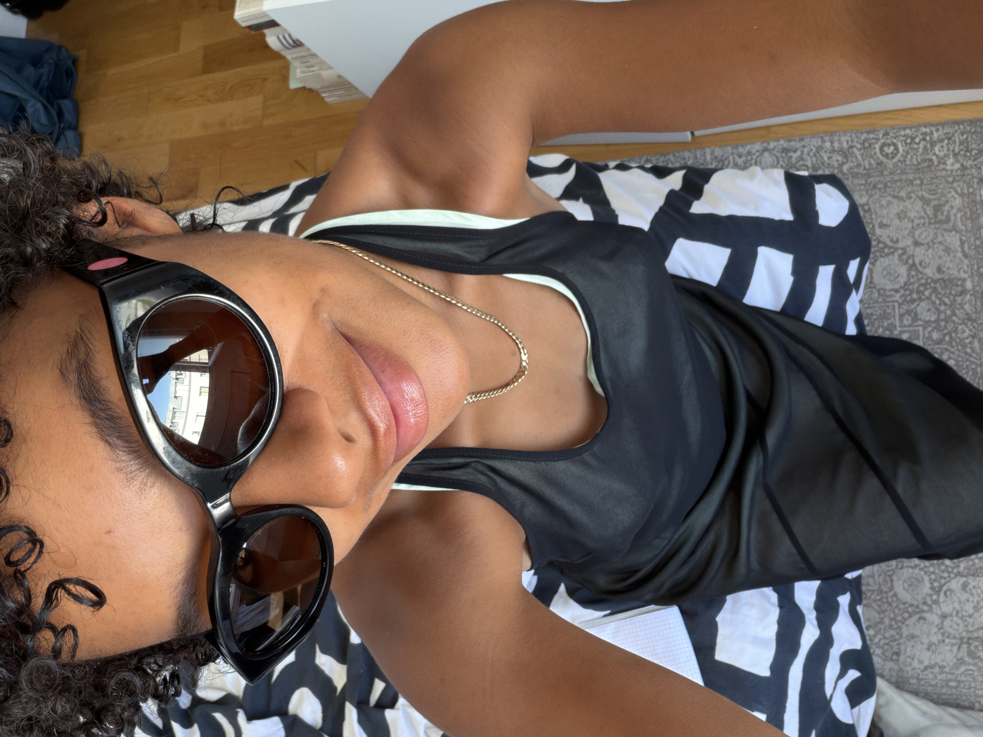 Selfie series in Paris, cat-eye shades on a patterned bed