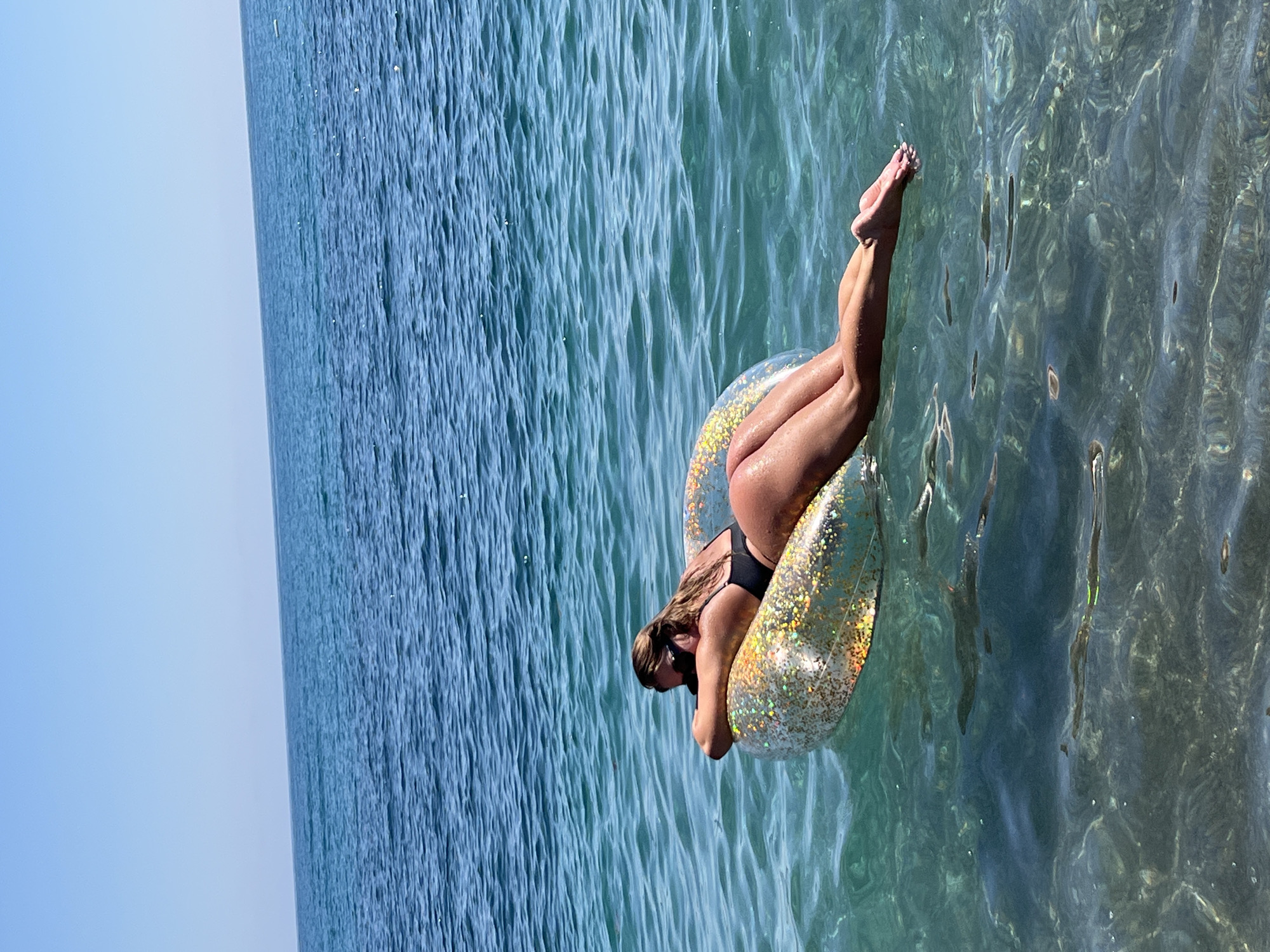 Woman enjoys sunny beach day in Prijevor, Montenegro waters
