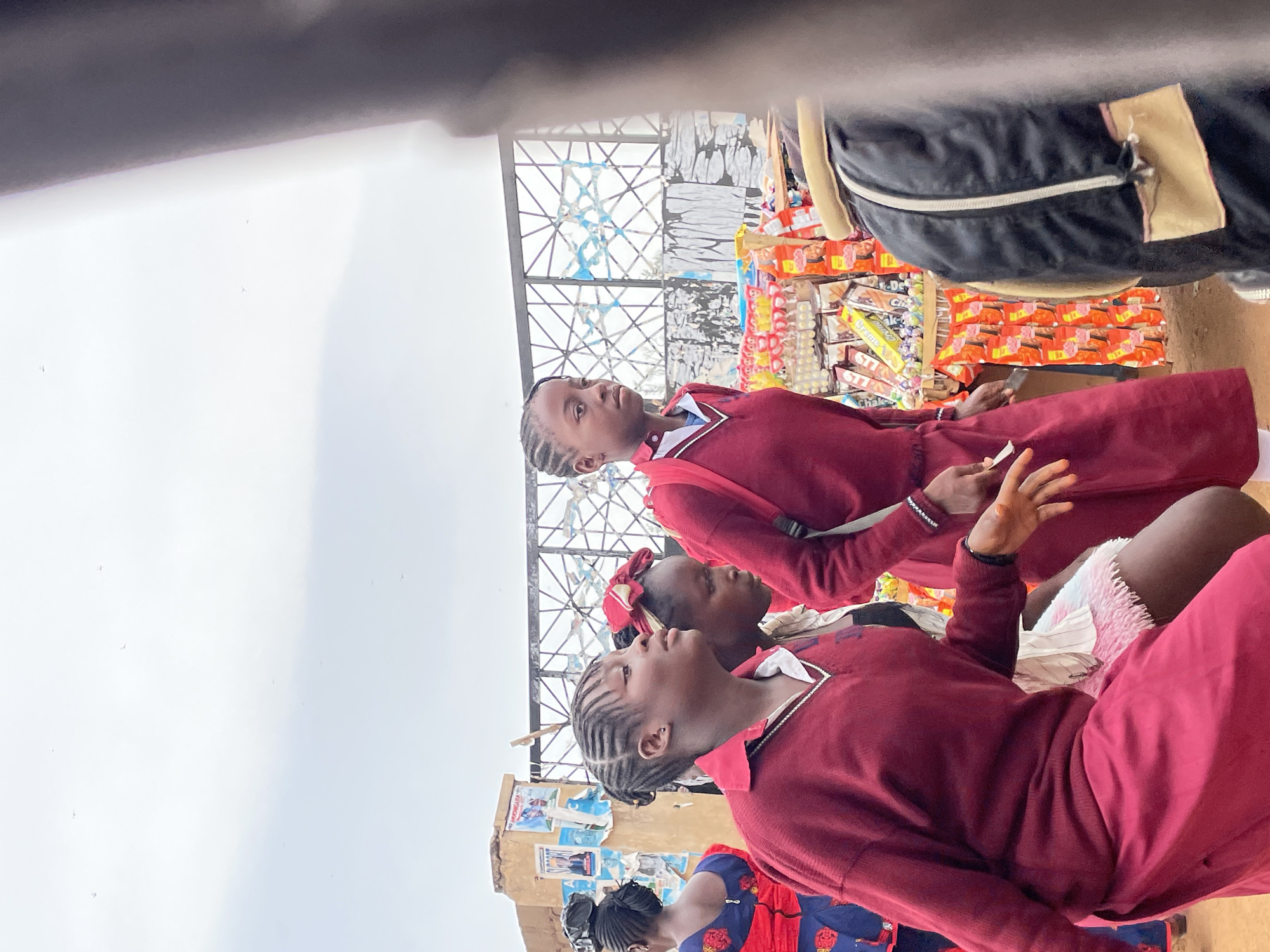 Schoolgirls and man observed in Jos, Nigeria market area