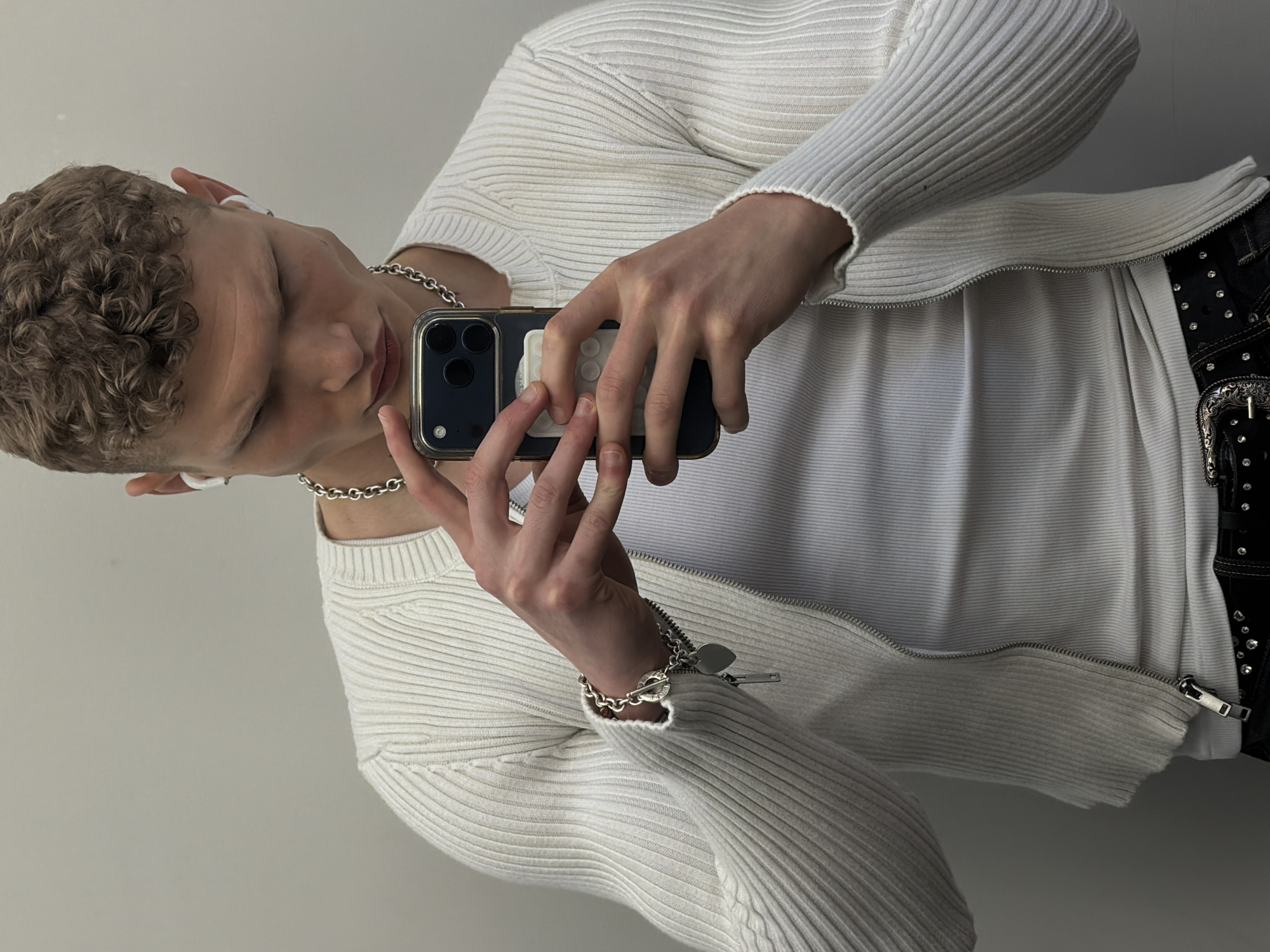Young person takes mirror selfie in London