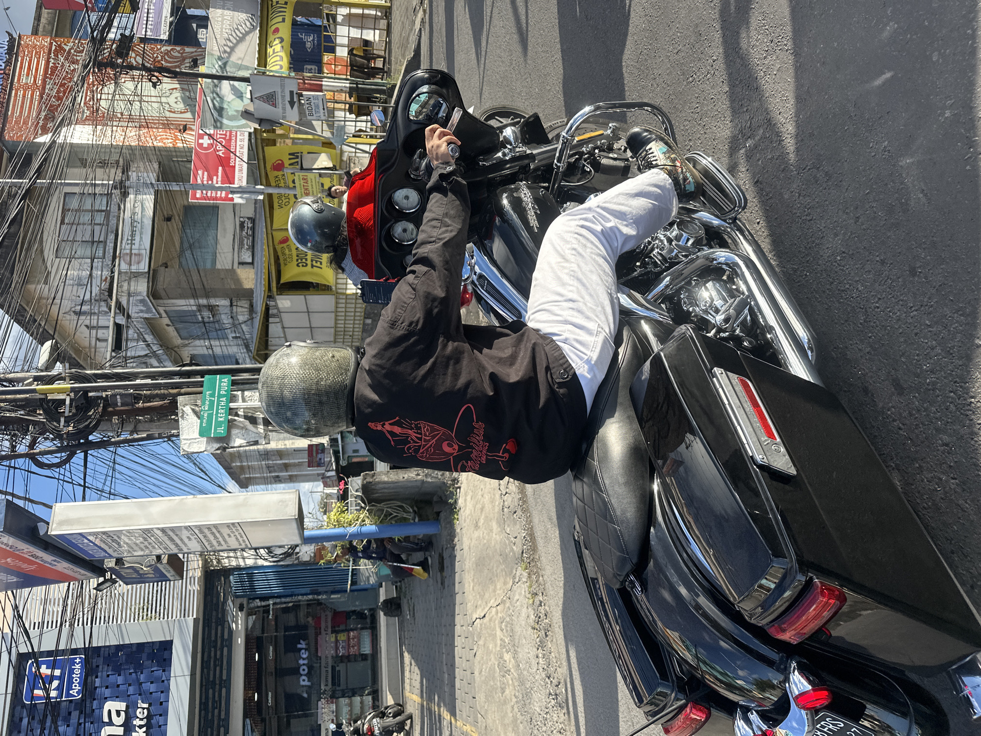 Morning motorcycle traffic on a busy Denpasar street
