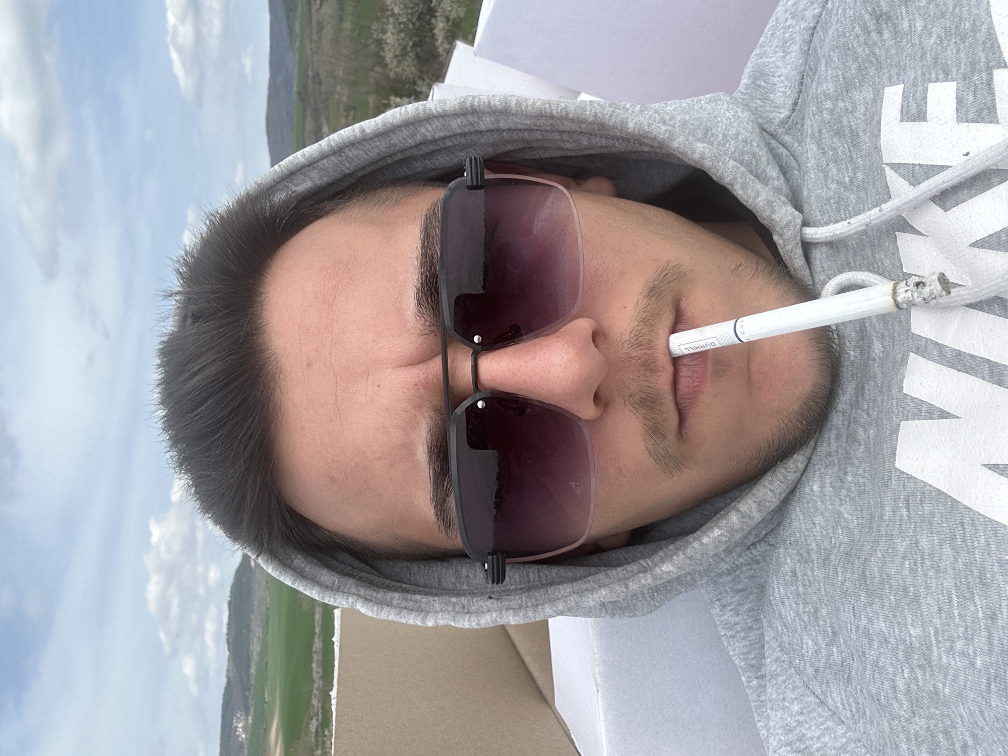 Man smoking cigarette observed in rural Novosel, Bulgaria