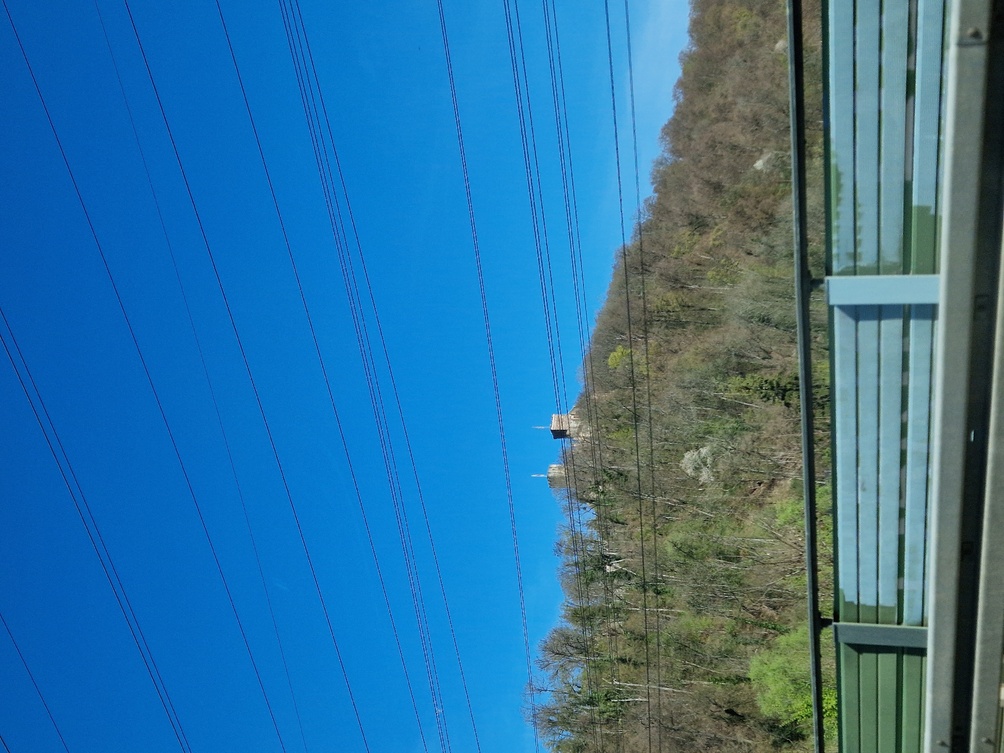 Power lines documented against blue sky in Lörrach, Germany