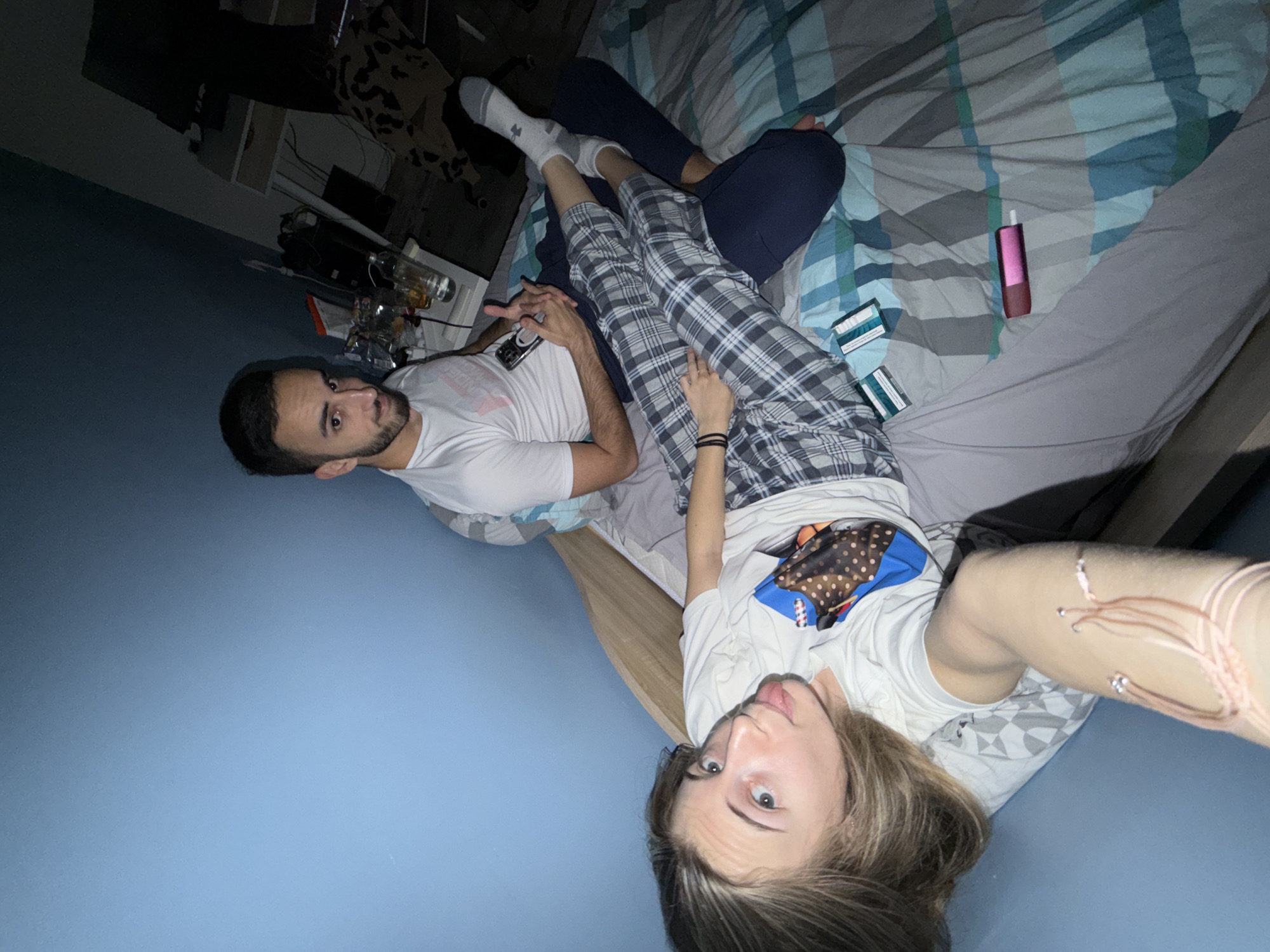 Two people relax on bed with phone in Plovdiv